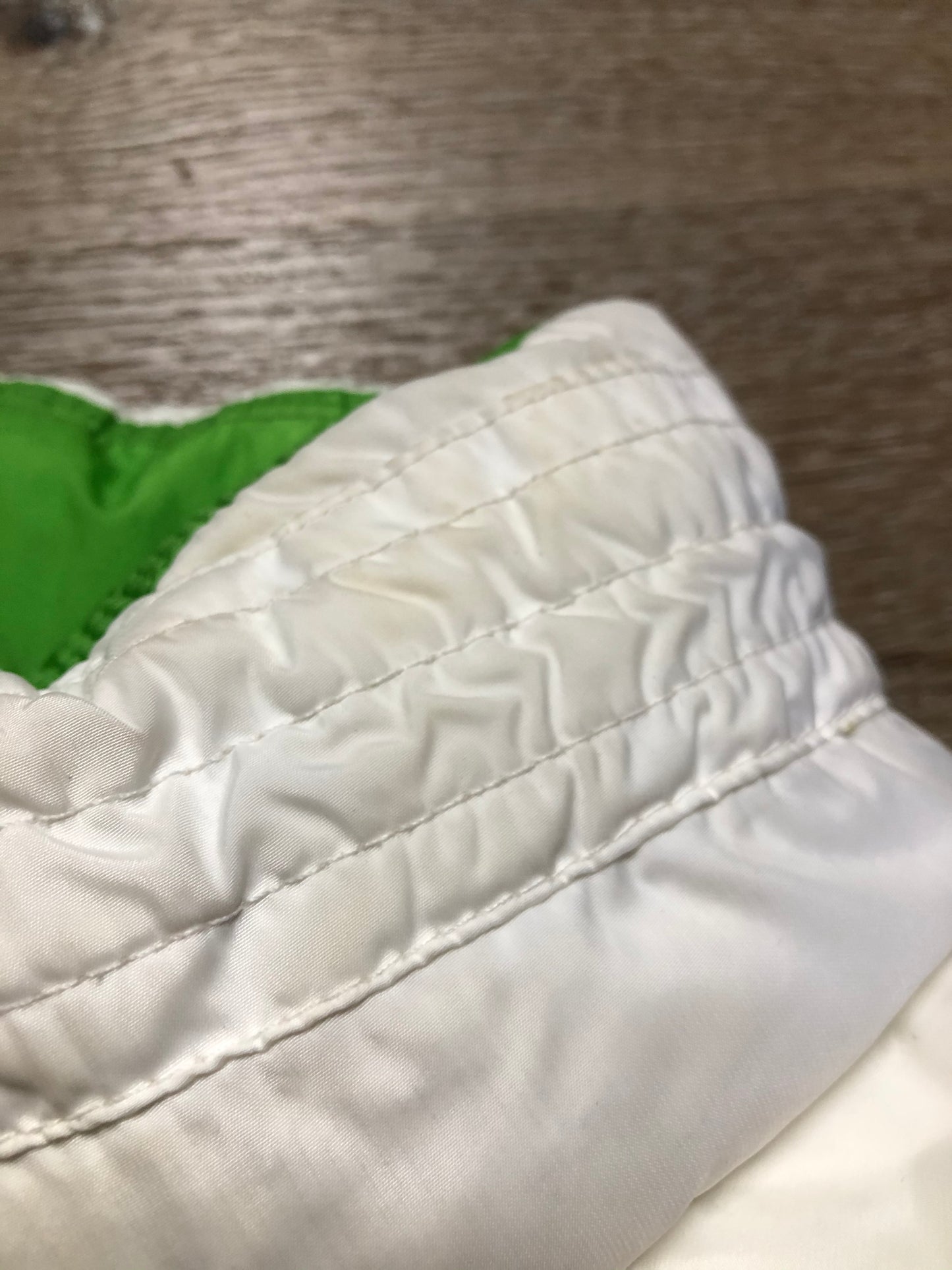 Kingspier Vintage - Nike white and green reversible down filled vest with zipper closure and slash pockets. size small.