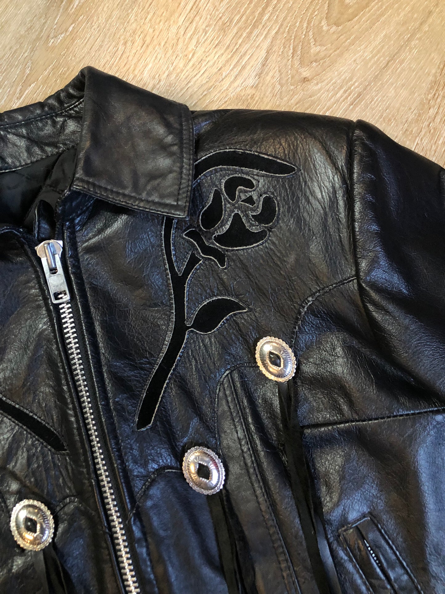 Kingspier Vintage - Vintage 1980’s Bristol “Golden Crown” black leather motorcycle jacket with leather fringe, suede rose applique in the front and back, silver hardware, lace up sides zipper closure, zip pockets and a quilted lining. Made in Canada. Women’s size small.