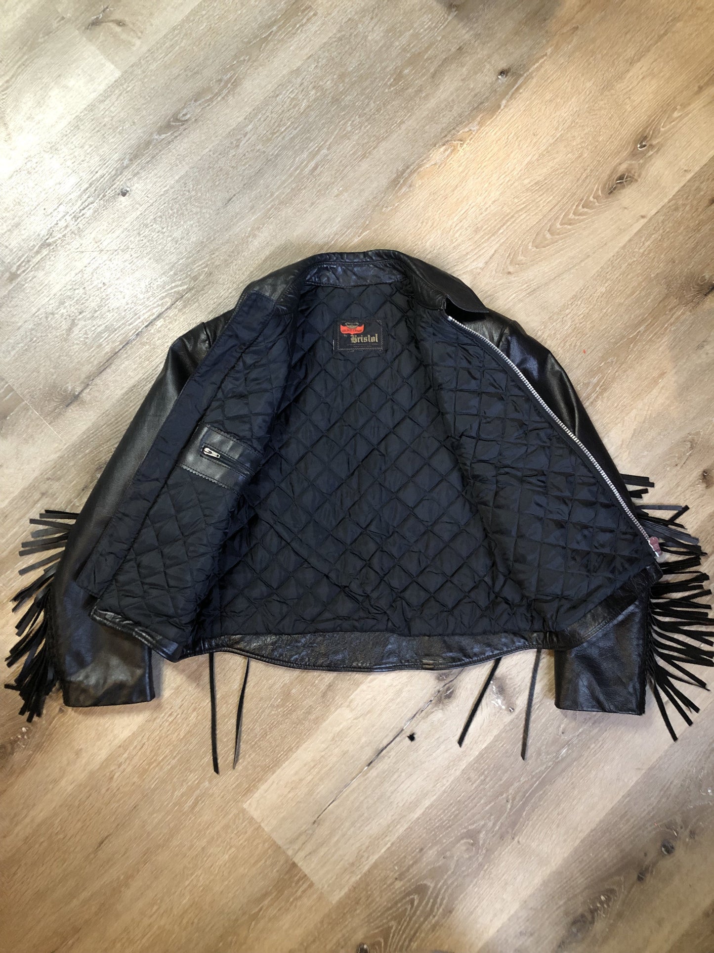 Kingspier Vintage - Vintage 1980’s Bristol “Golden Crown” black leather motorcycle jacket with leather fringe, suede rose applique in the front and back, silver hardware, lace up sides zipper closure, zip pockets and a quilted lining. Made in Canada. Women’s size small.