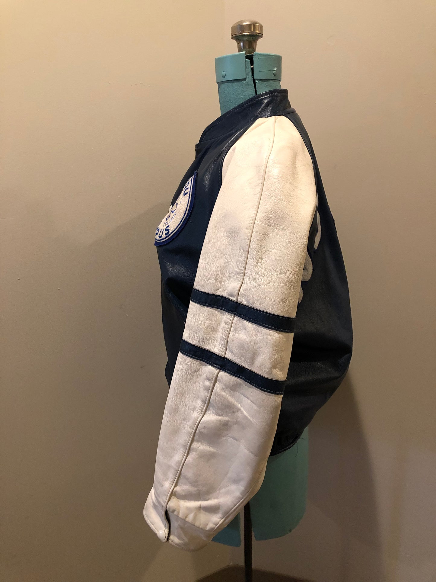 Kingspier Vintage - Vintage NSCC Pictou Campus leather varsity jacket in blue and white with snap closures, slash pockets, “Pictou Campus” embroidered on the chest, “NSCC” Embroidered on the back and “Ron” monogram embroidered on the sleeve,