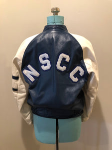 Kingspier Vintage - Vintage NSCC Pictou Campus leather varsity jacket in blue and white with snap closures, slash pockets, “Pictou Campus” embroidered on the chest, “NSCC” Embroidered on the back and “Ron” monogram embroidered on the sleeve,
