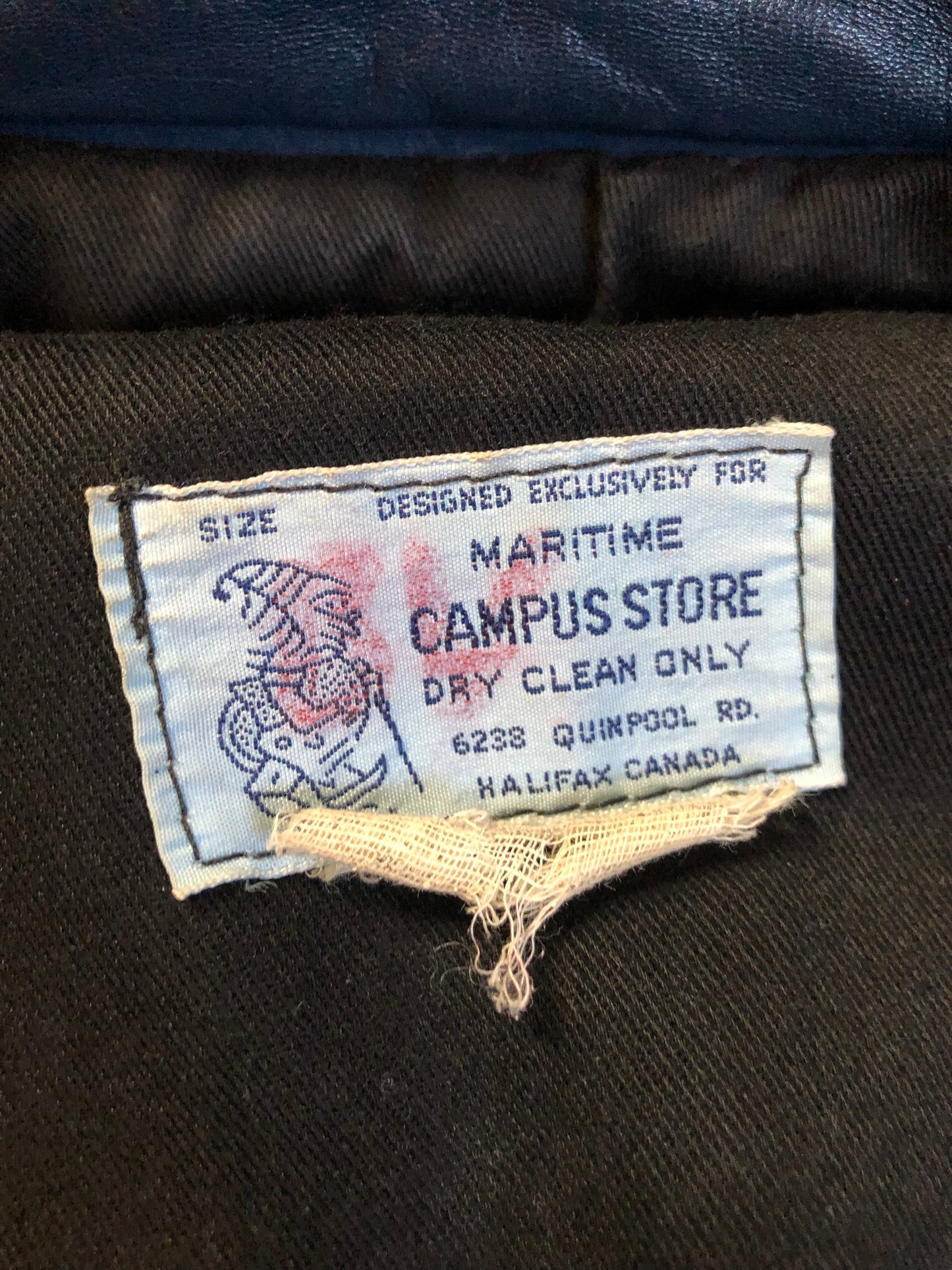 Kingspier Vintage - Vintage NSCC Pictou Campus leather varsity jacket in blue and white with snap closures, slash pockets, “Pictou Campus” embroidered on the chest, “NSCC” Embroidered on the back and “Ron” monogram embroidered on the sleeve,
