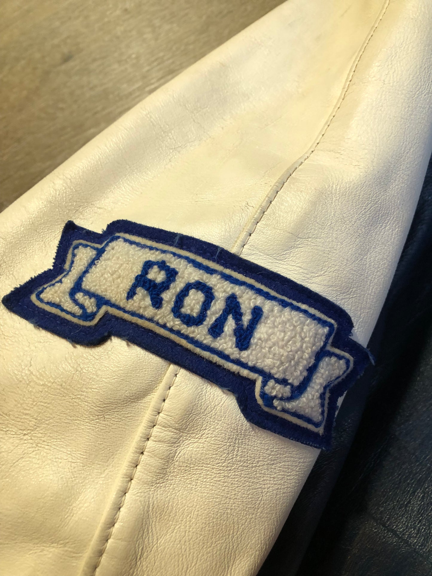Kingspier Vintage - Vintage NSCC Pictou Campus leather varsity jacket in blue and white with snap closures, slash pockets, “Pictou Campus” embroidered on the chest, “NSCC” Embroidered on the back and “Ron” monogram embroidered on the sleeve,