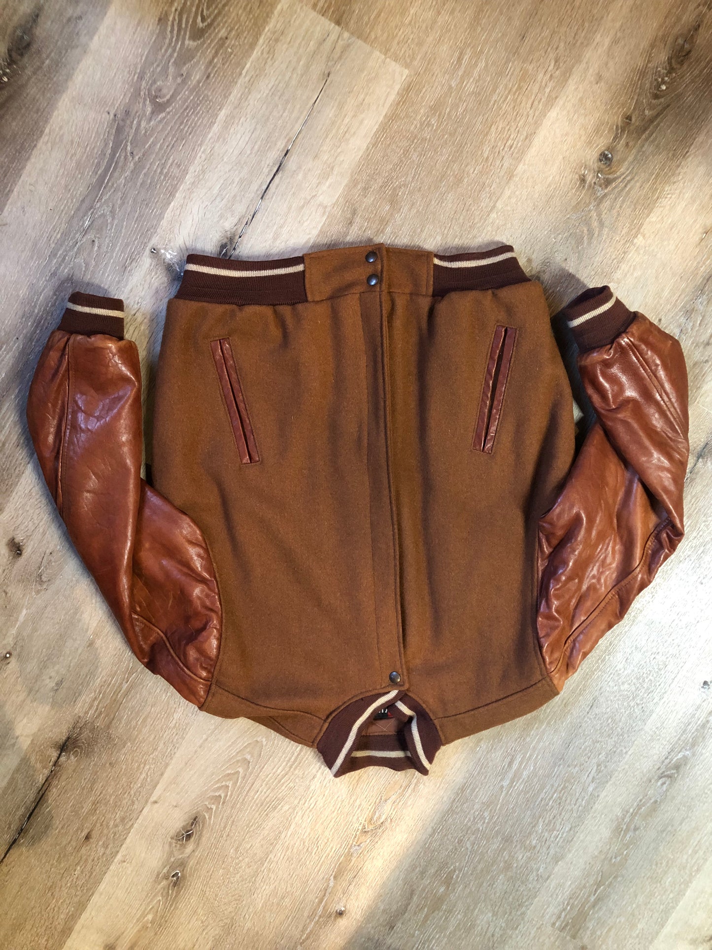 Kingspier Vintage - Rumors and Gossyp brown wool blend varsity style jacket with very soft leather sleeves, snap closures, vertical pockets, knit trim and quilted lining. Made in Canada. Size small.
