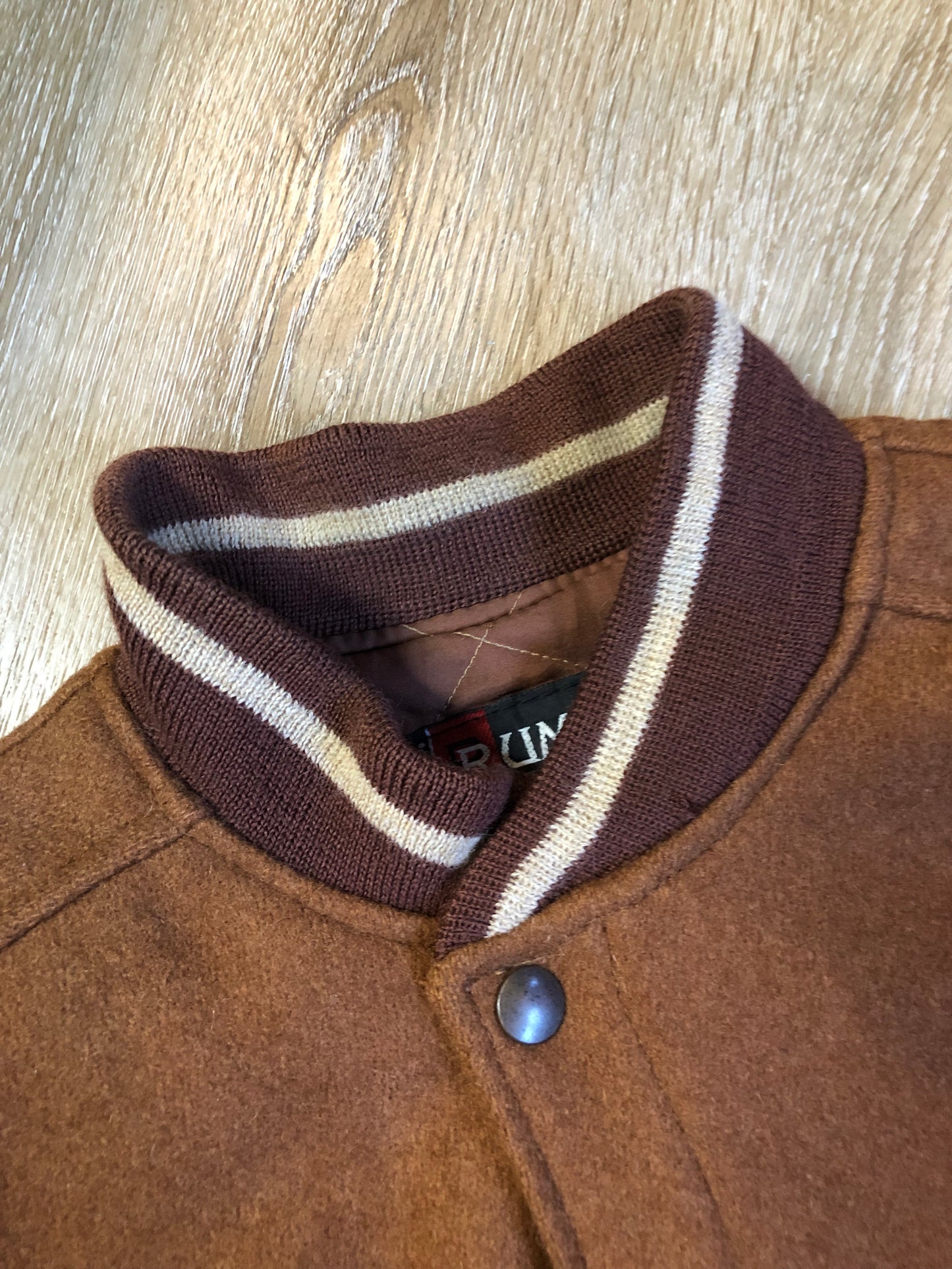 Kingspier Vintage - Rumors and Gossyp brown wool blend varsity style jacket with very soft leather sleeves, snap closures, vertical pockets, knit trim and quilted lining. Made in Canada. Size small.