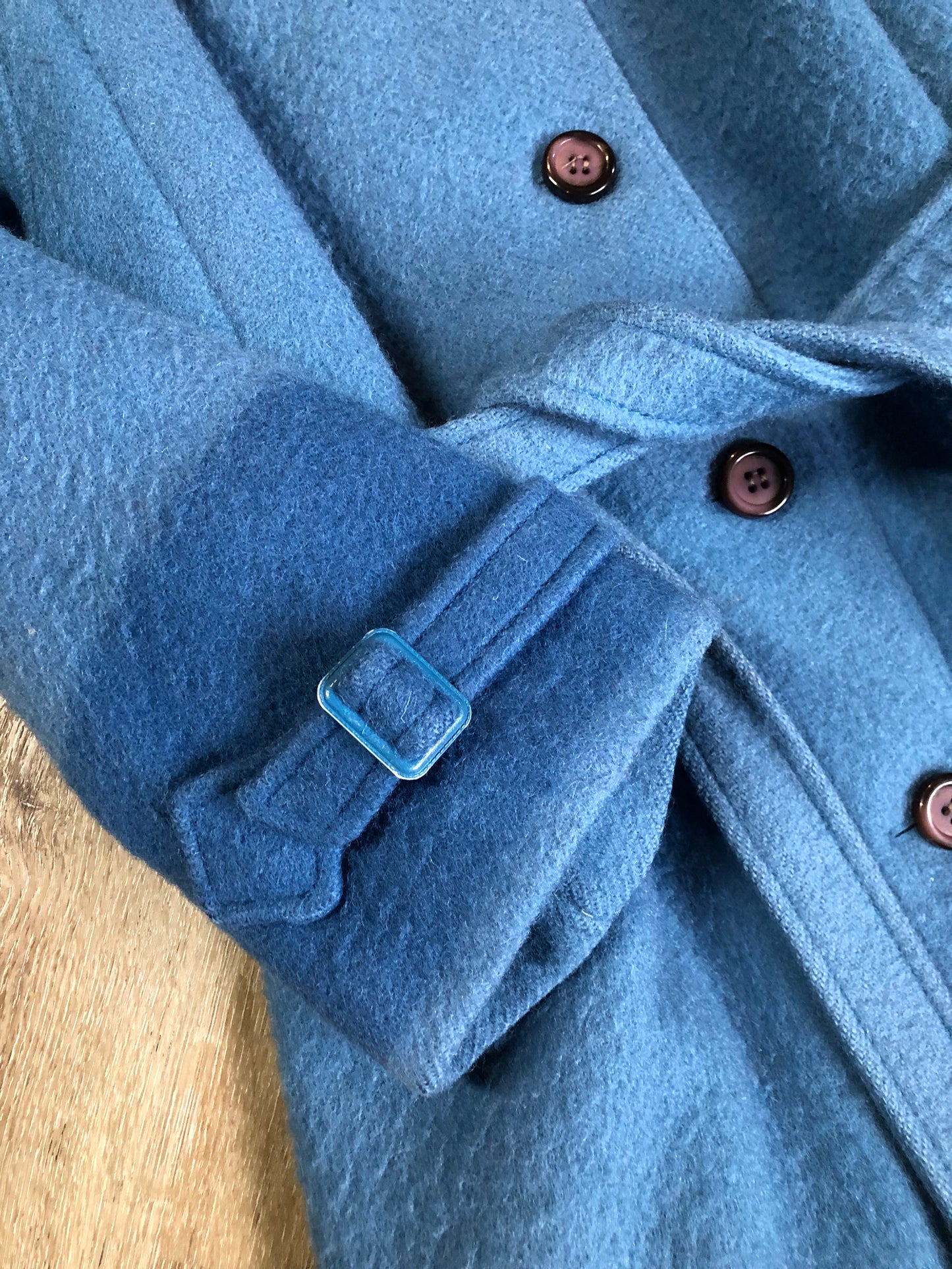 Kingspier Vintage - Hudson’s Bay Company blue and black stripe 100% virgin wool point blanket coat in a swing coat style with belt, buckle detail at the collar, button closures, slash pockets and blue satin lining. Made in England. Size large.
