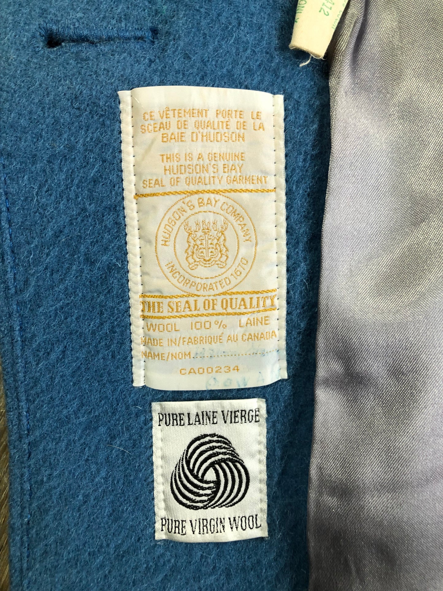 Kingspier Vintage - Hudson’s Bay Company blue and black stripe 100% virgin wool point blanket coat in a swing coat style with belt, buckle detail at the collar, button closures, slash pockets and blue satin lining. Made in England. Size large.