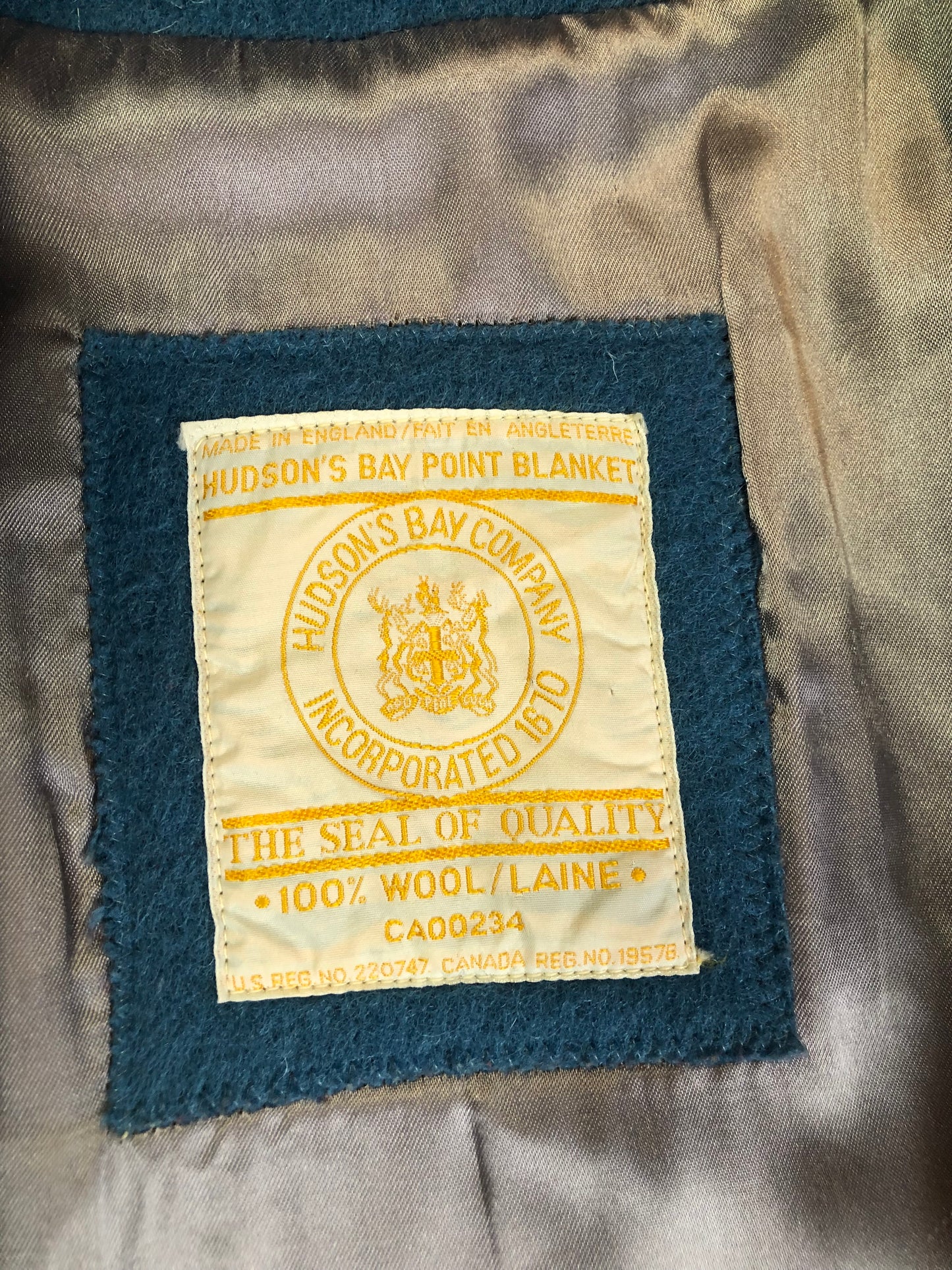 Kingspier Vintage - Hudson’s Bay Company blue and black stripe 100% virgin wool point blanket coat in a swing coat style with belt, buckle detail at the collar, button closures, slash pockets and blue satin lining. Made in England. Size large.