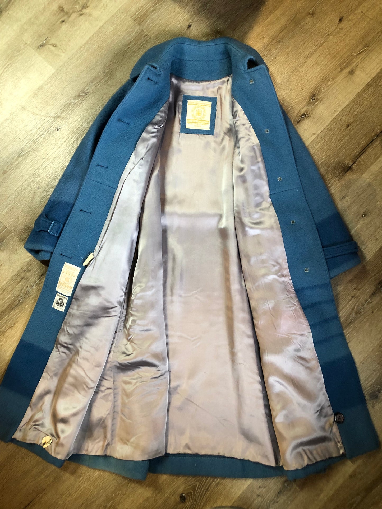 Kingspier Vintage - Hudson’s Bay Company blue and black stripe 100% virgin wool point blanket coat in a swing coat style with belt, buckle detail at the collar, button closures, slash pockets and blue satin lining. Made in England. Size large.