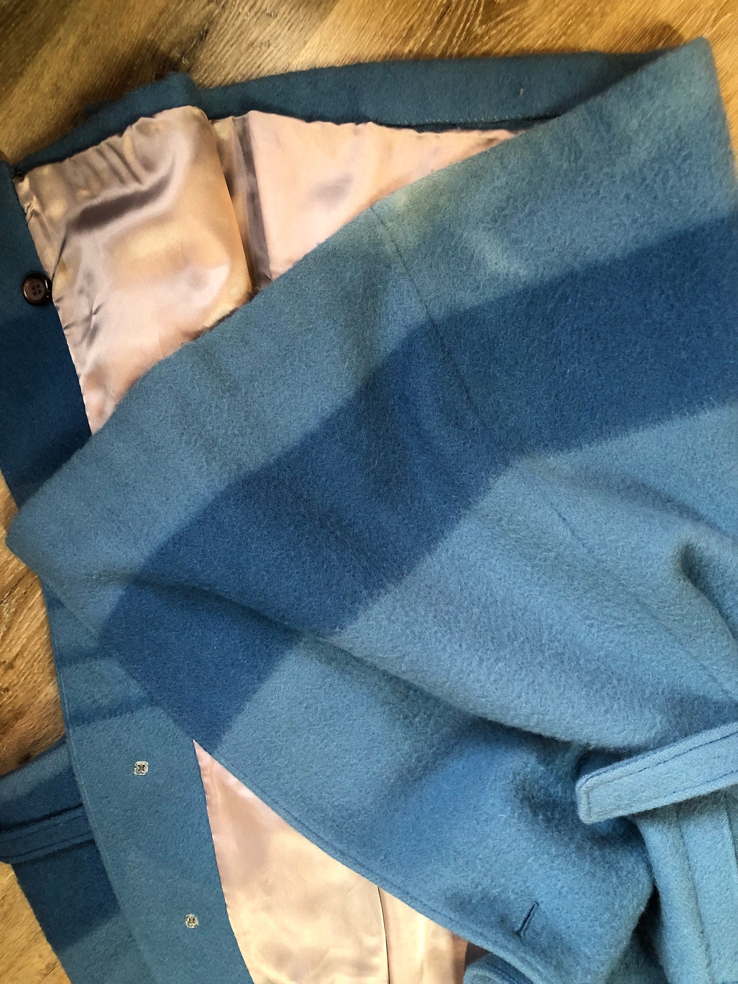 Kingspier Vintage - Hudson’s Bay Company blue and black stripe 100% virgin wool point blanket coat in a swing coat style with belt, buckle detail at the collar, button closures, slash pockets and blue satin lining. Made in England. Size large.