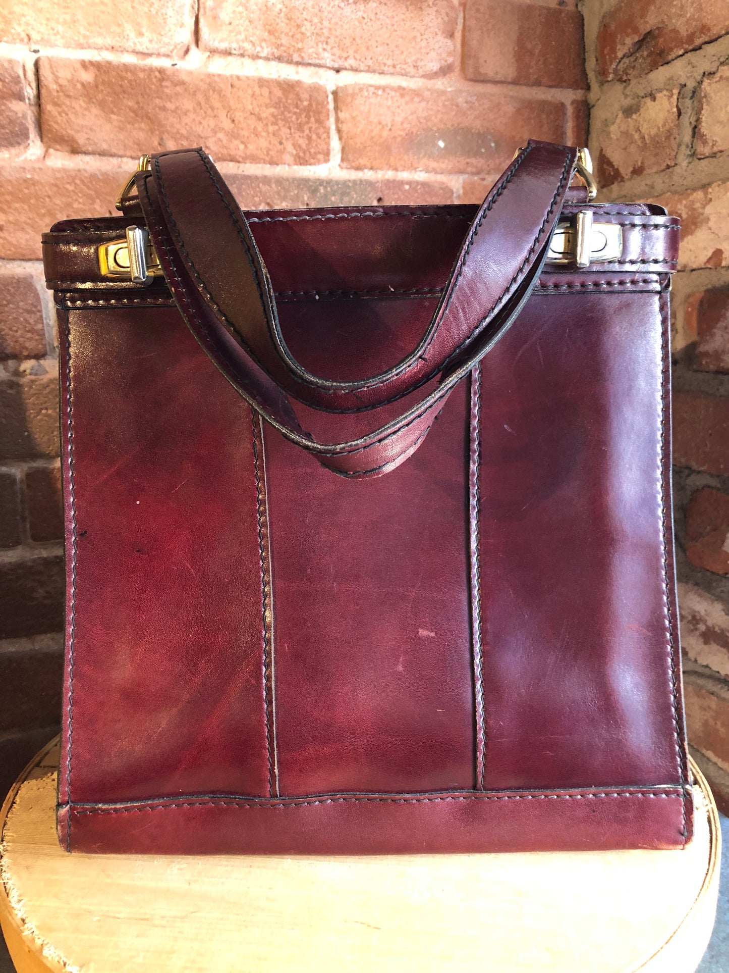Kingspier Vintage - Caggiano deep red calfskin leather purse with brass hardware, two buckles on each side to allow the top to open fully, inside dividers and pockets. Made in Italy.