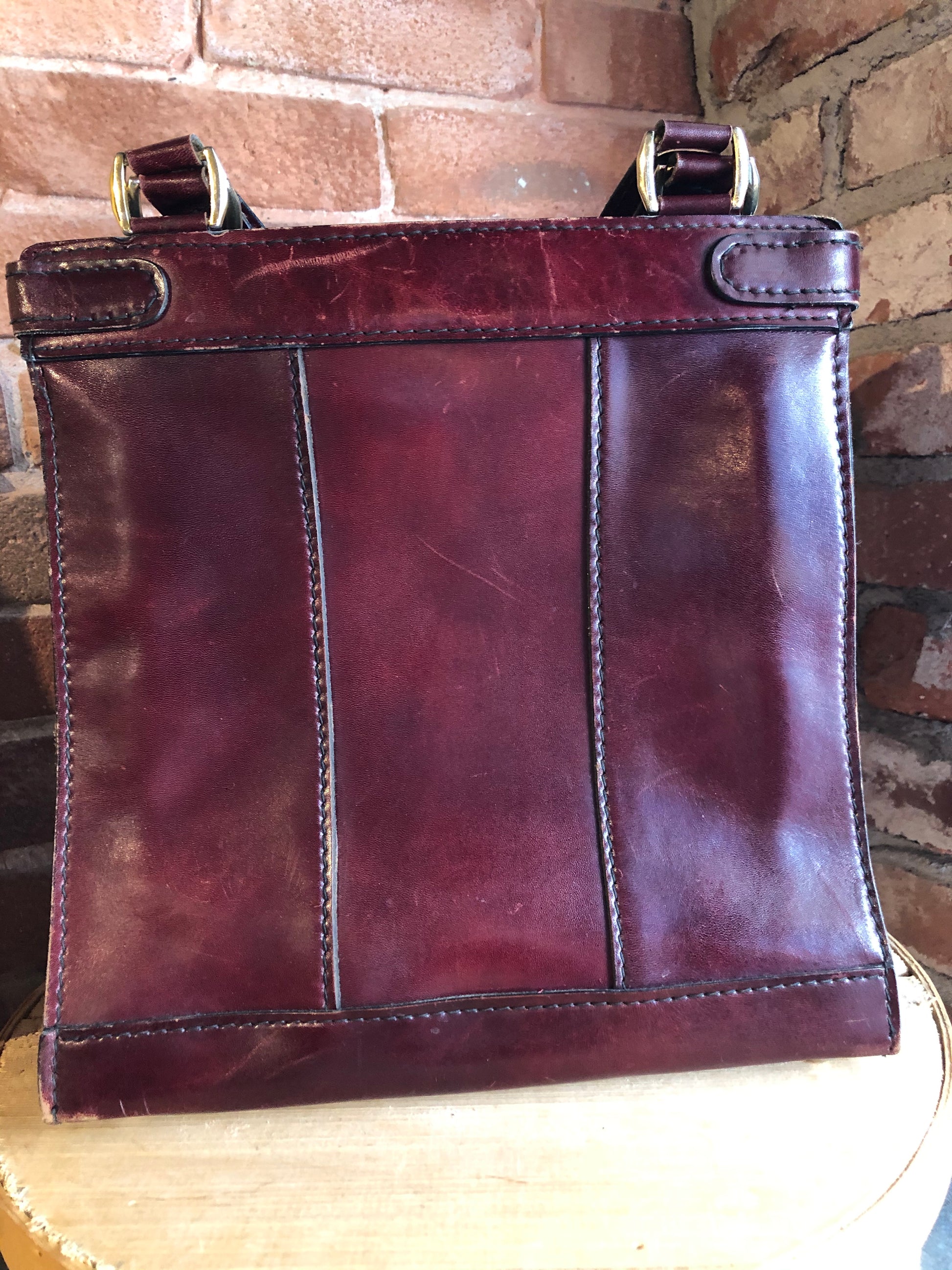 Kingspier Vintage - Caggiano deep red calfskin leather purse with brass hardware, two buckles on each side to allow the top to open fully, inside dividers and pockets. Made in Italy.
