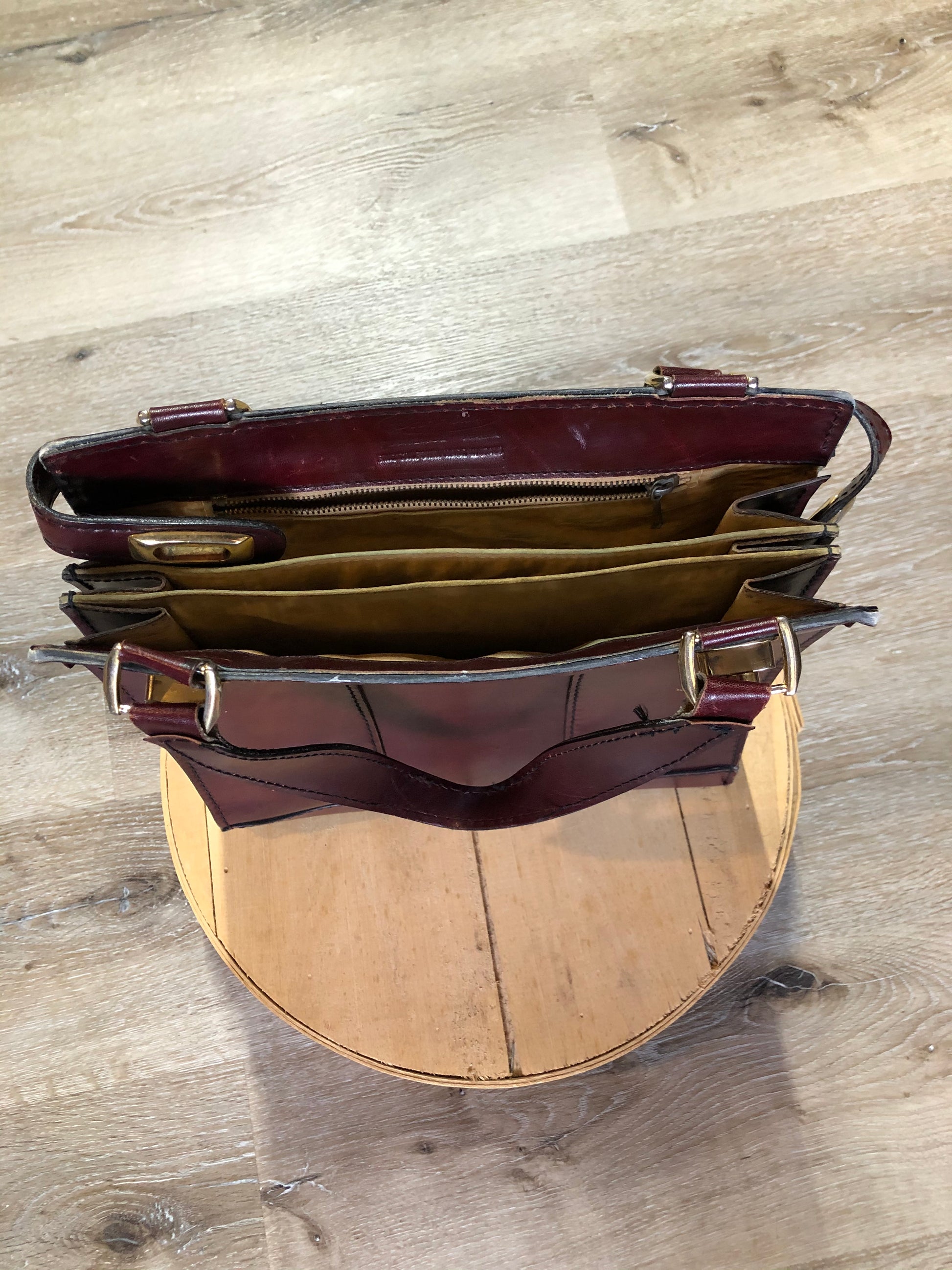 Kingspier Vintage - Caggiano deep red calfskin leather purse with brass hardware, two buckles on each side to allow the top to open fully, inside dividers and pockets. Made in Italy.