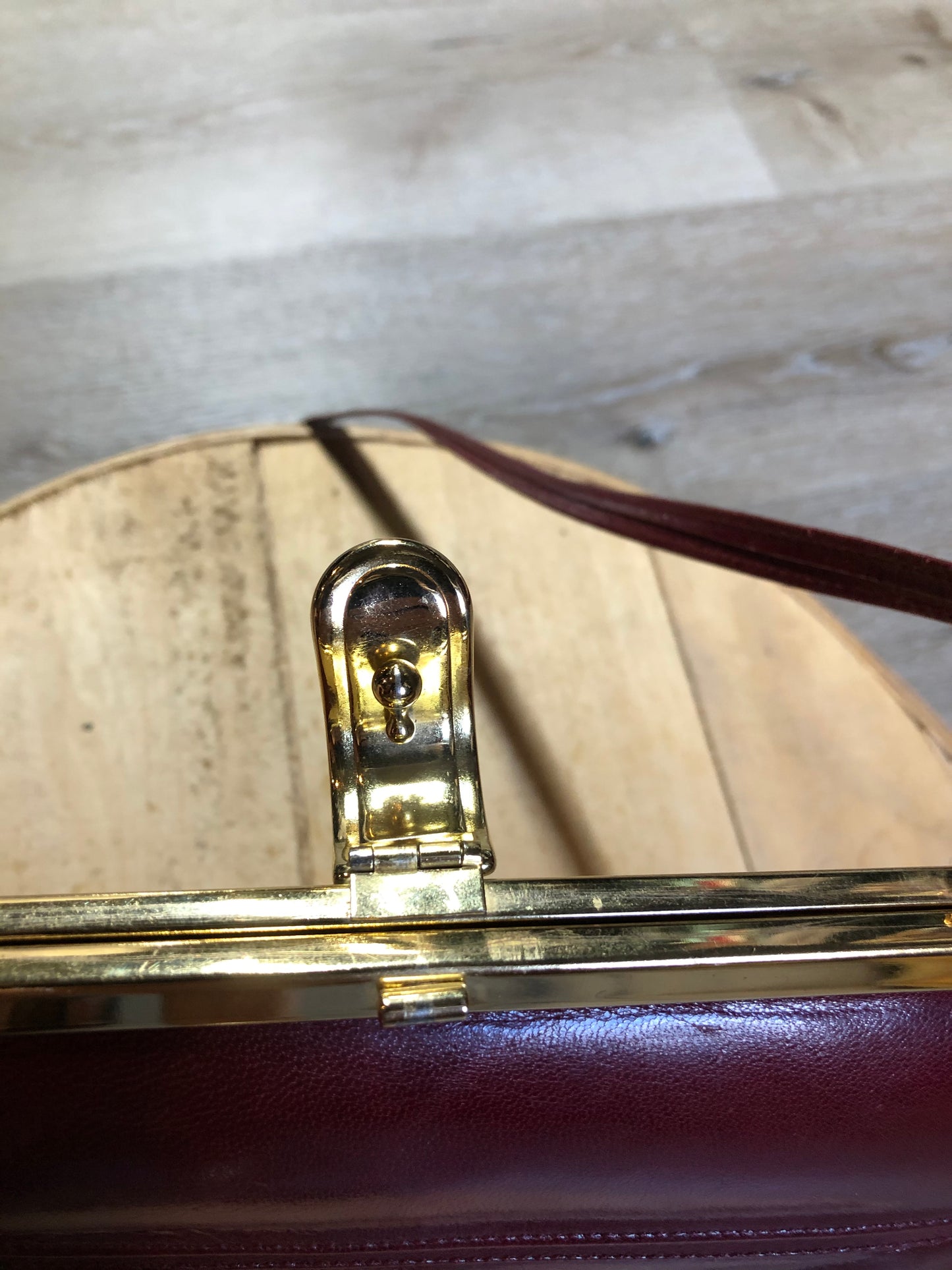 Kingspier Vintage - Deep red leather handbag circa 1950’s with brass metal details and clasp.