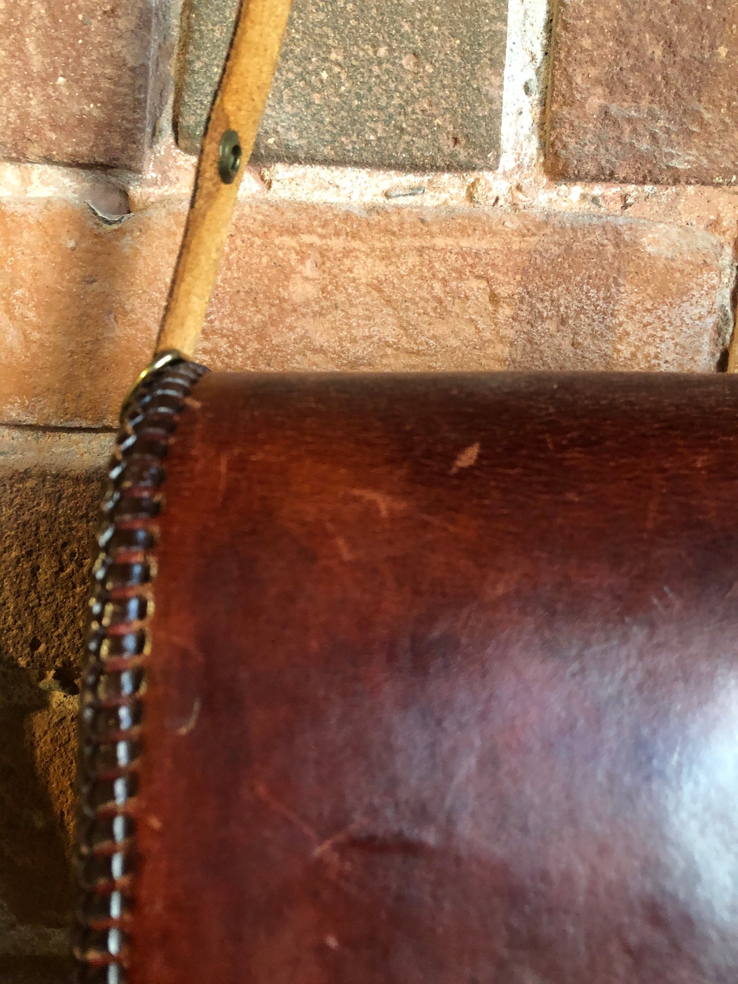 Kingspier Vintage - Hand tooled brown leather purse with leather stitching around the trim and a red leather flower motif lining.