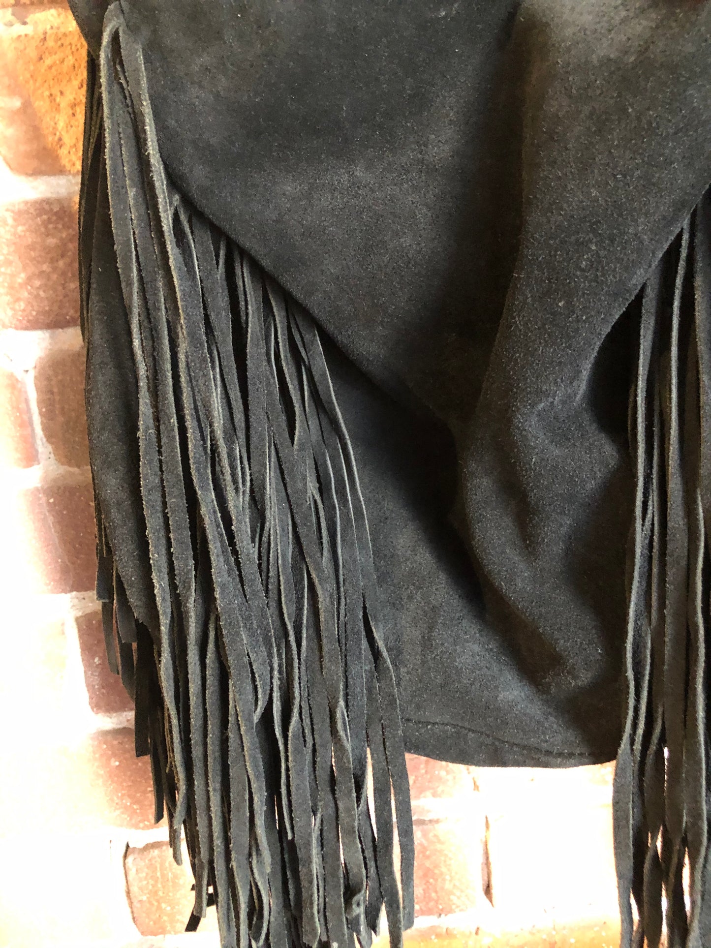 Kingspier Vintage - Zara black suede fringe crossbody bag with magnetic closures and adjustable strap.