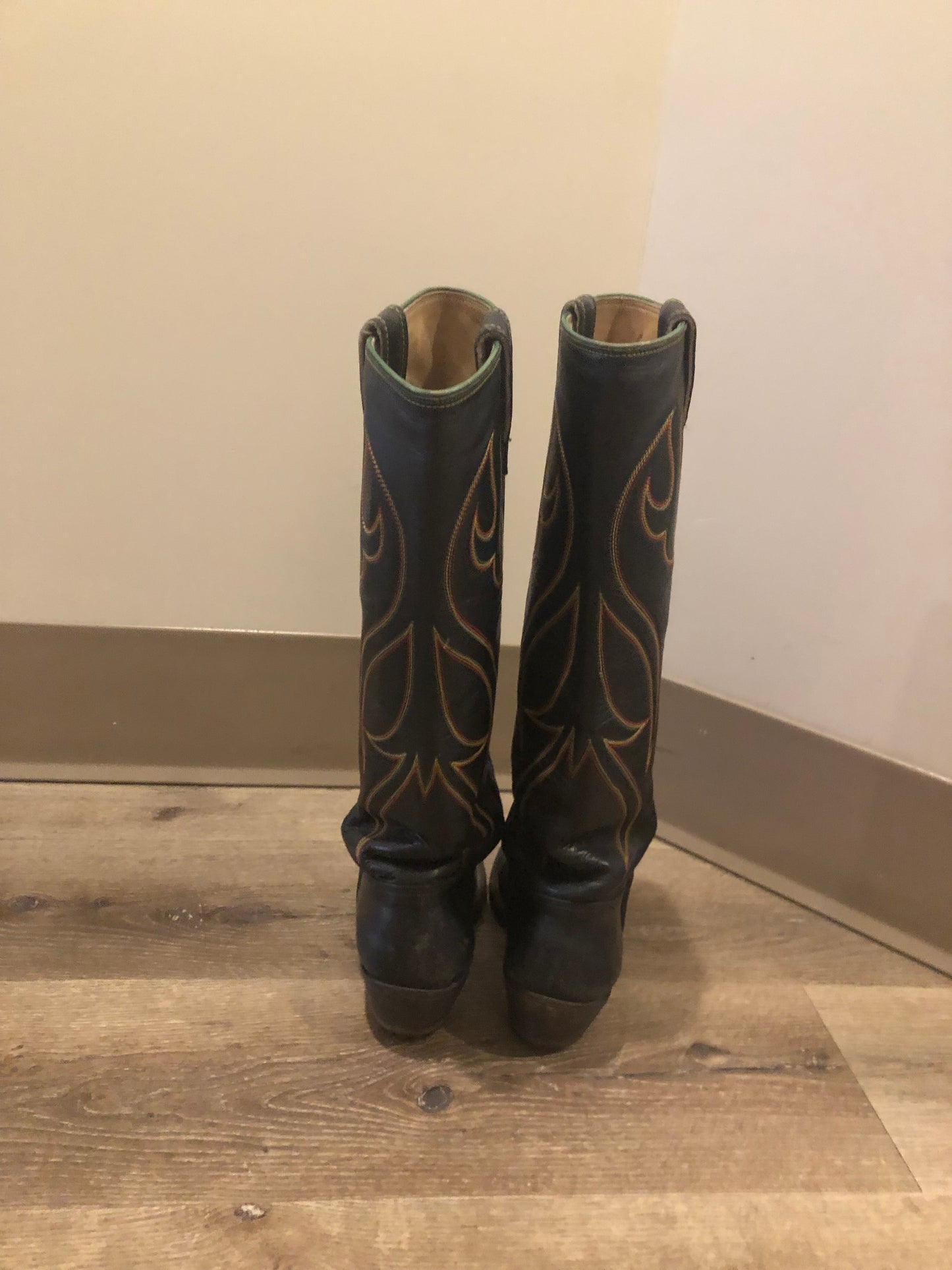 Stewart Co knee high leather cowboy boots in black with rainbow stitching. Leather lined with leather soles. Made in USA Size 7.5W US, 38 EUR
