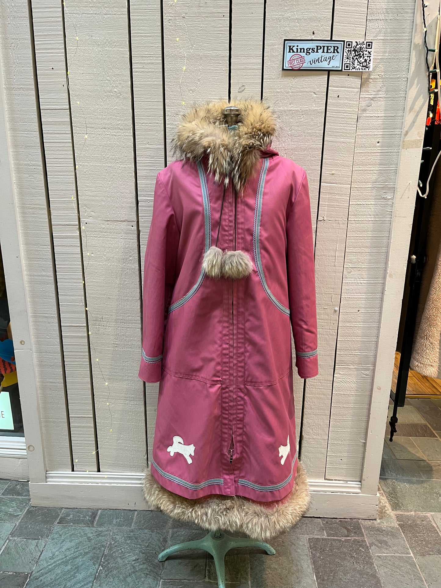 Vintage Yukon Indian Arts and Crafts LTD 100% pure virgin wool northern parka and nylon/ cotton blend removable shell with white leather applique, fur trimmed hood and pom poms, zipper closure, pockets, and hand embroidered flower details.
Made in USA
Size 16