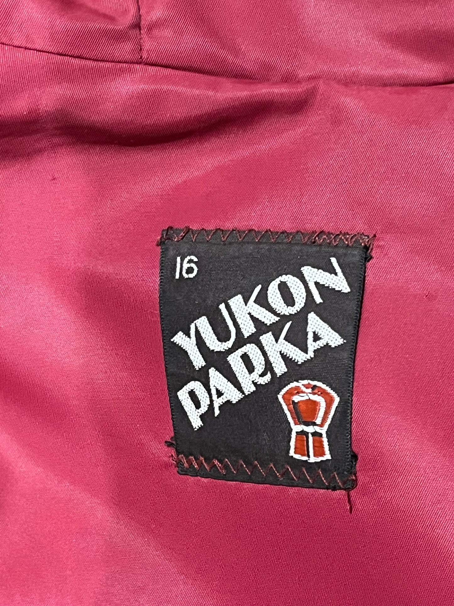 Vintage Yukon Indian Arts and Crafts LTD 100% pure virgin wool northern parka and nylon/ cotton blend removable shell with white leather applique, fur trimmed hood and pom poms, zipper closure, pockets, and hand embroidered flower details.
Made in USA
Size 16