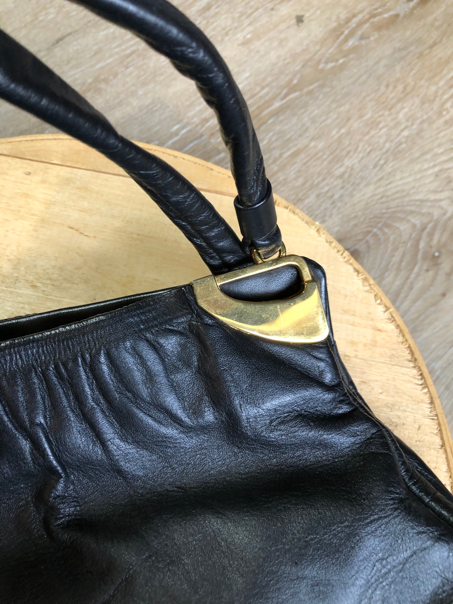 Kingspier Vintage - Jane Shilton black leather handbag with top handle, gold hardware and inside change purse compartment.