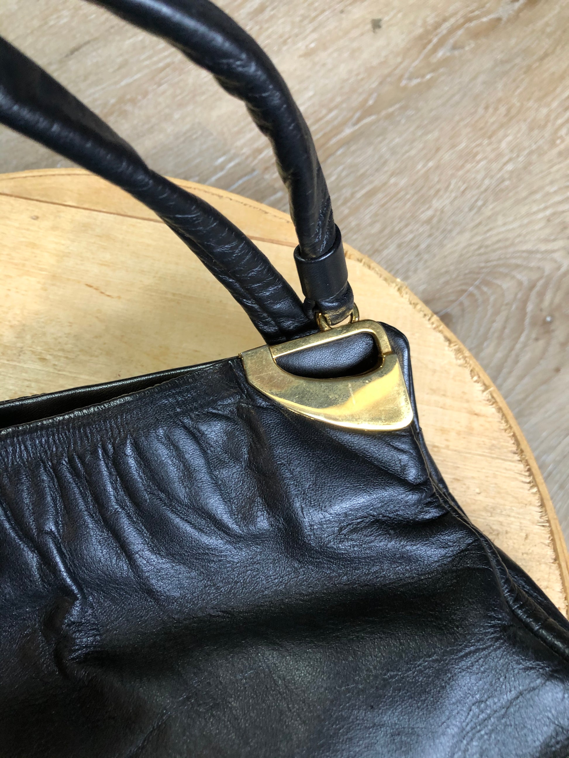Kingspier Vintage - Jane Shilton black leather handbag with top handle, gold hardware and inside change purse compartment.