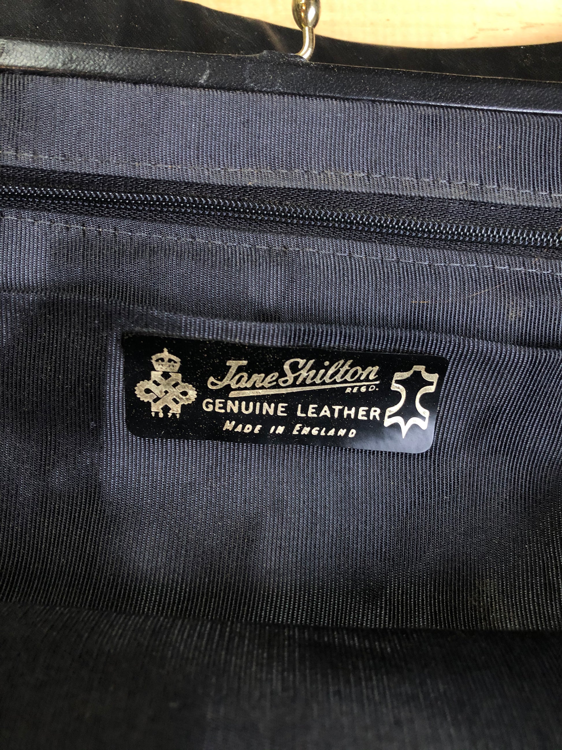 Kingspier Vintage - Jane Shilton black leather handbag with top handle, gold hardware and inside change purse compartment.