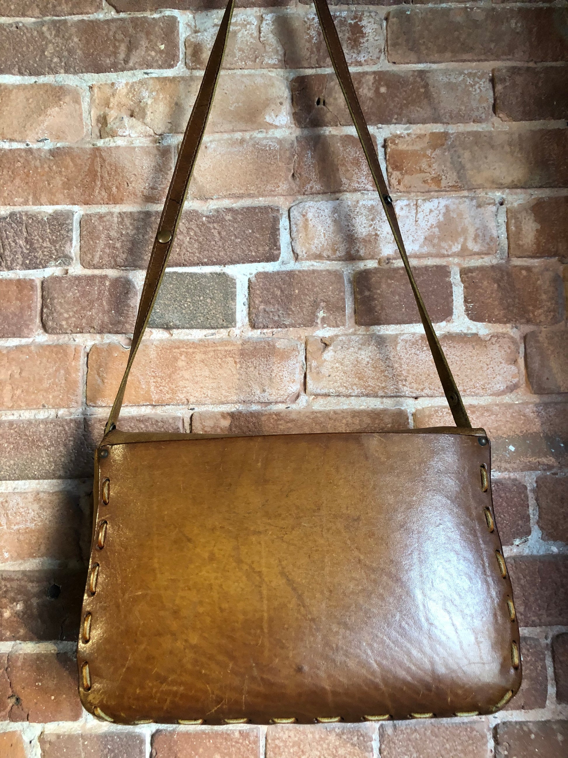 Kingspier Vintage - Hand tooled leather saddle bag with leather stitching, adjustable strap and brass front clasp.