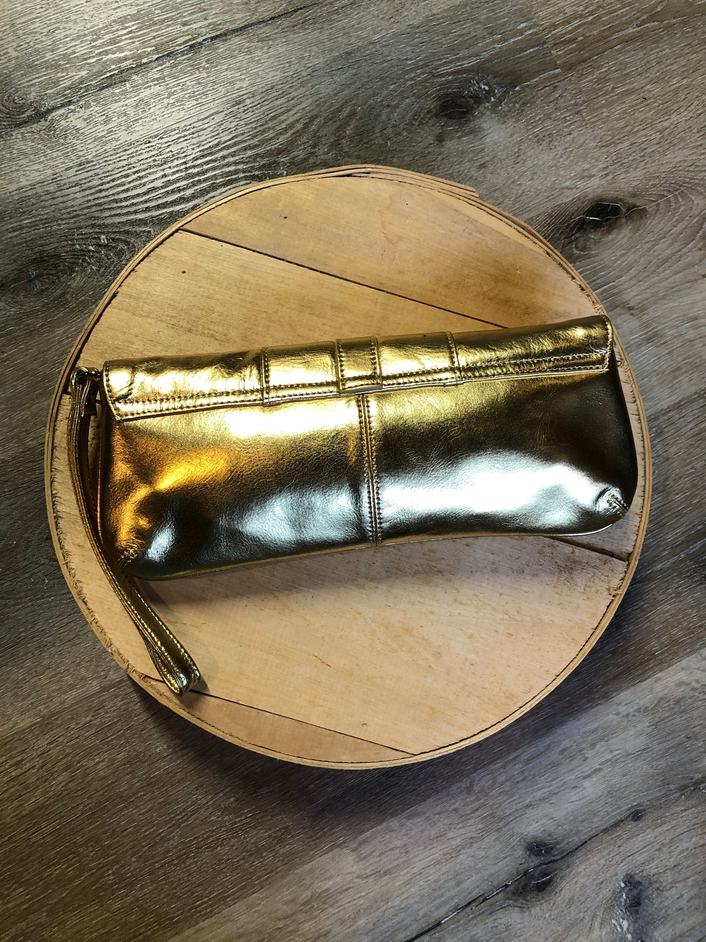 Kingspier Vintage - Danier gold leather flap clutch with magnetic buckle closure, inside zip pocket and wrist strap.