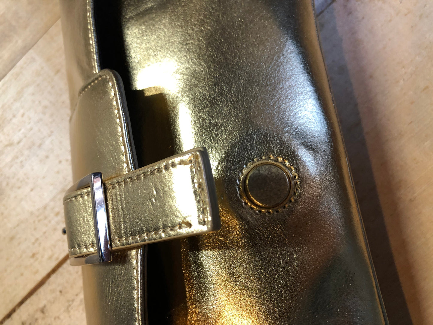 Kingspier Vintage - Danier gold leather flap clutch with magnetic buckle closure, inside zip pocket and wrist strap.