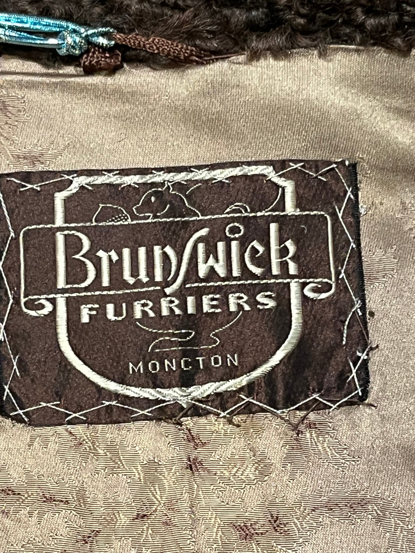 Vintage Brunswick Furriers brown persian lamb jacket with fur collar, two front pockets, flower decorated button closures and a “N.G.S” monogram on the inside lining.
Made in Canada, Chest 38”