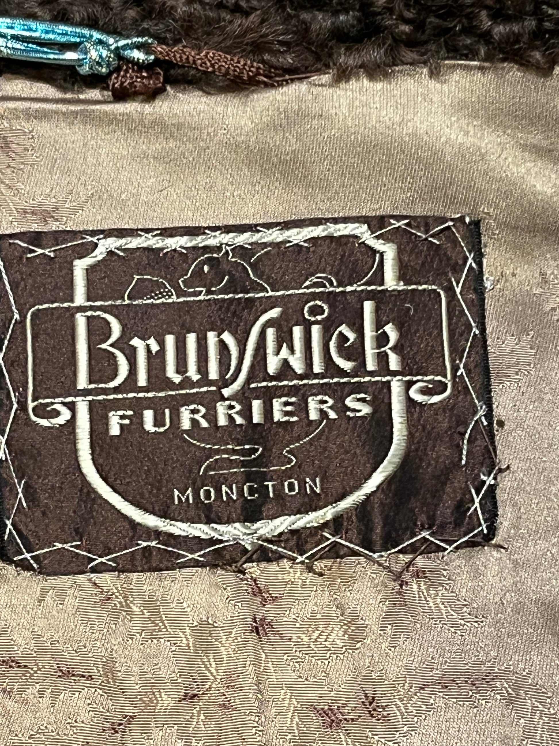 Vintage Brunswick Furriers brown persian lamb jacket with fur collar, two front pockets, flower decorated button closures and a “N.G.S” monogram on the inside lining.
Made in Canada, Chest 38”