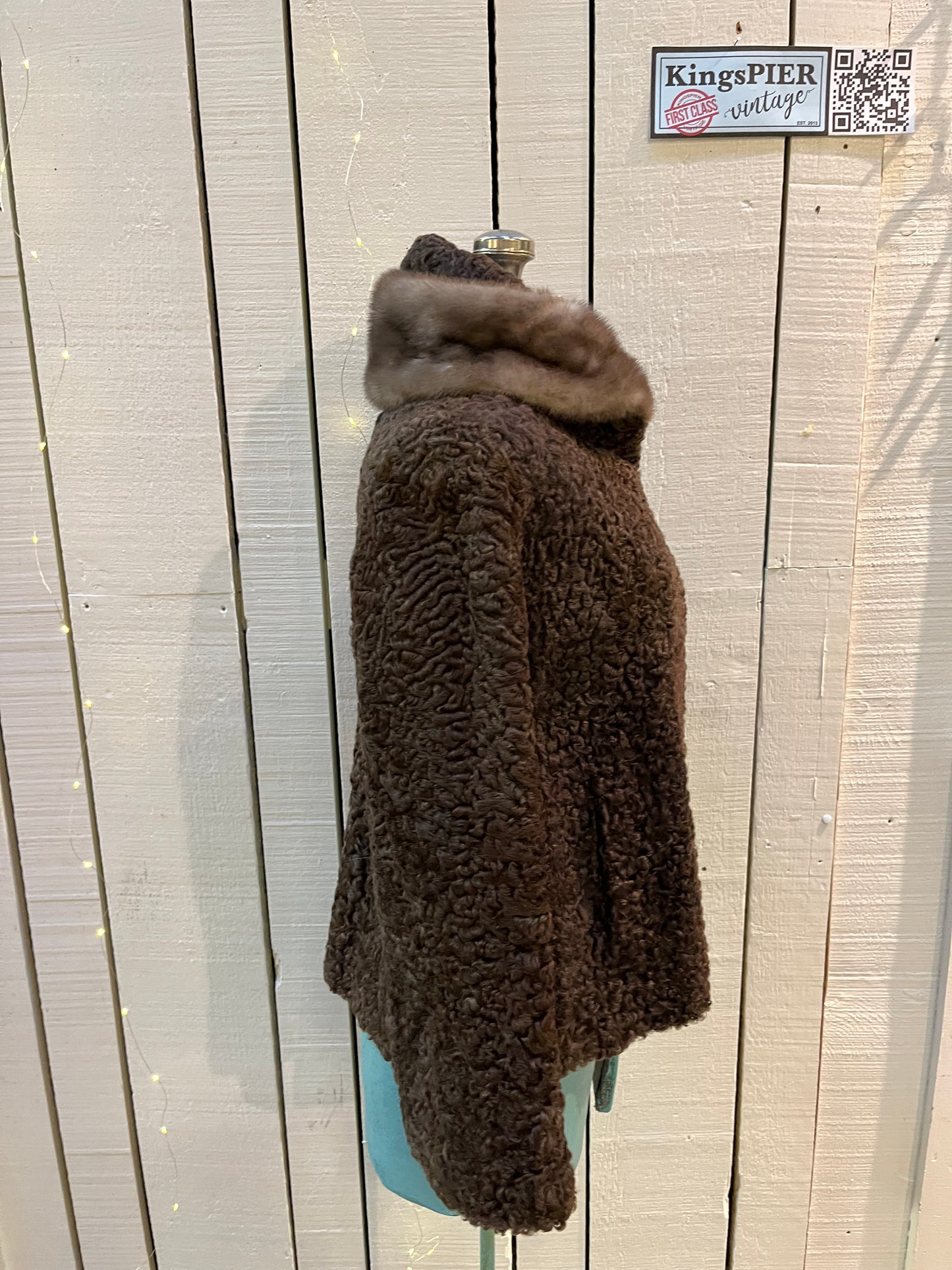 Vintage Brunswick Furriers brown persian lamb jacket with fur collar, two front pockets, flower decorated button closures and a “N.G.S” monogram on the inside lining.
Made in Canada, Chest 38”