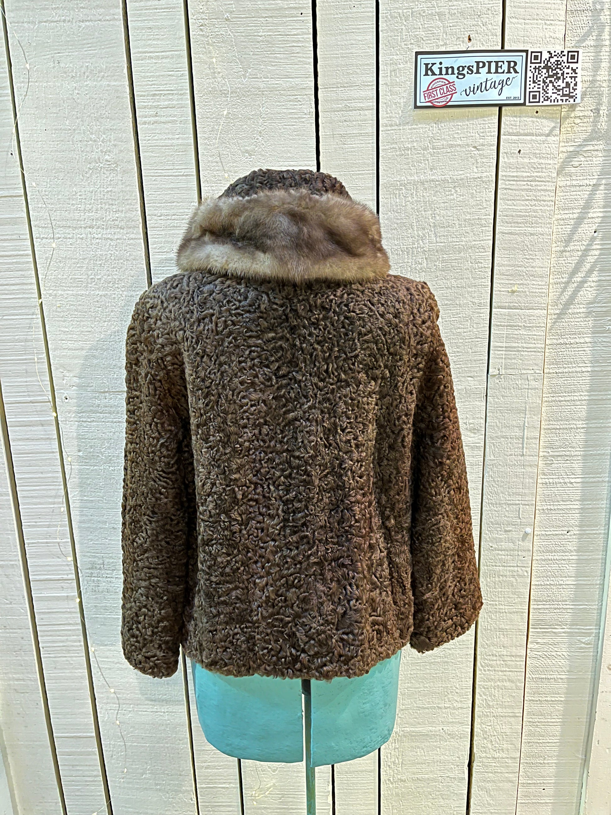 Vintage Brunswick Furriers brown persian lamb jacket with fur collar, two front pockets, flower decorated button closures and a “N.G.S” monogram on the inside lining.
Made in Canada, Chest 38”