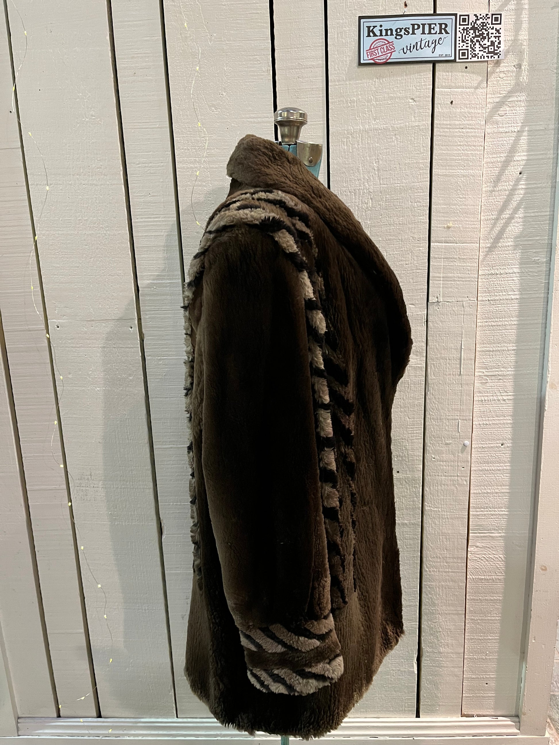 Vintage Eastern Furriers brown fur coat with hook and eye closures and two front pockets.
Although we can’t say for sure what the type of fur is, our educated guess is shorn beaver.
Made in Canada