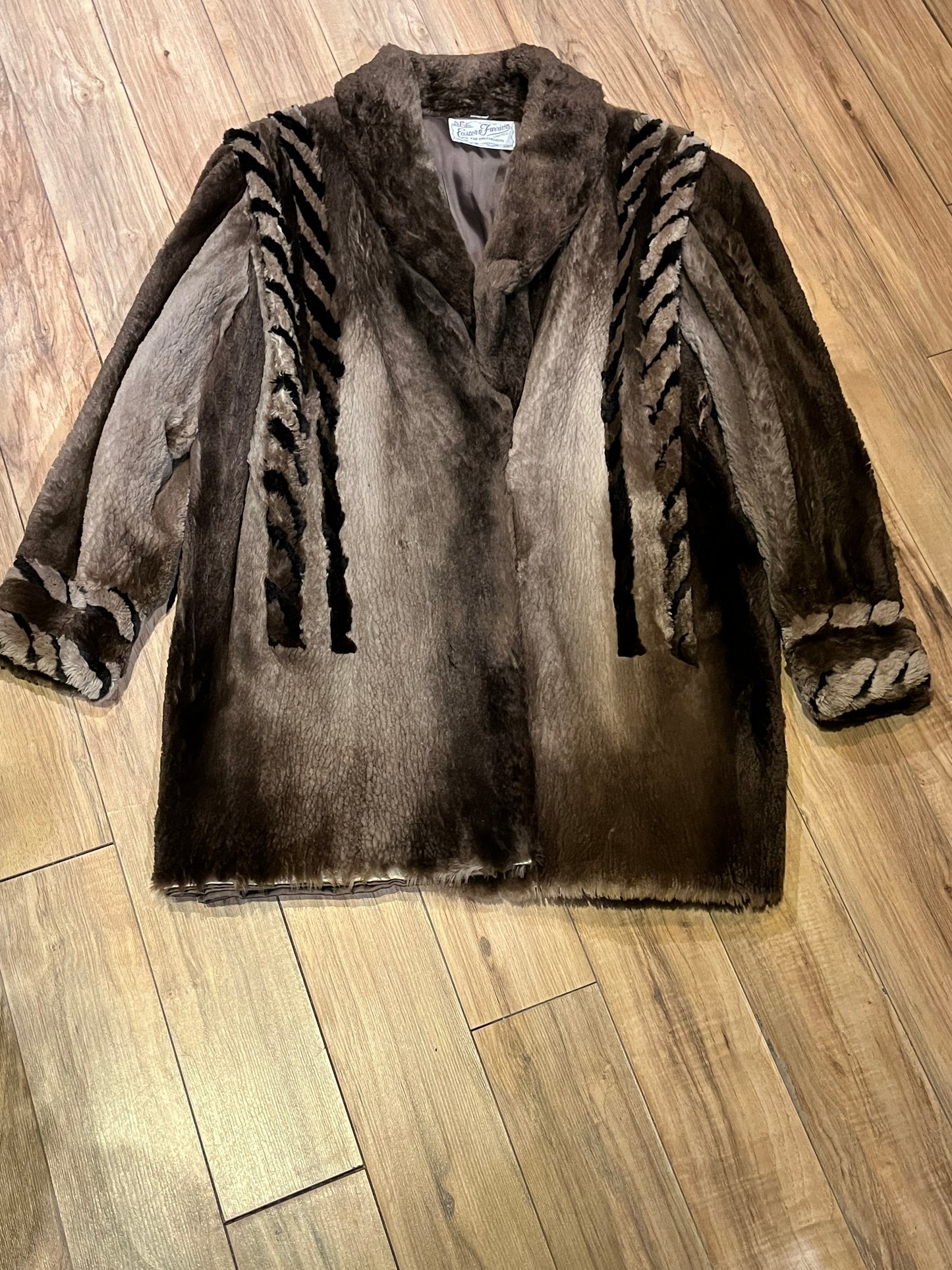 Vintage Eastern Furriers brown fur coat with hook and eye closures and two front pockets.
Although we can’t say for sure what the type of fur is, our educated guess is shorn beaver.
Made in Canada
