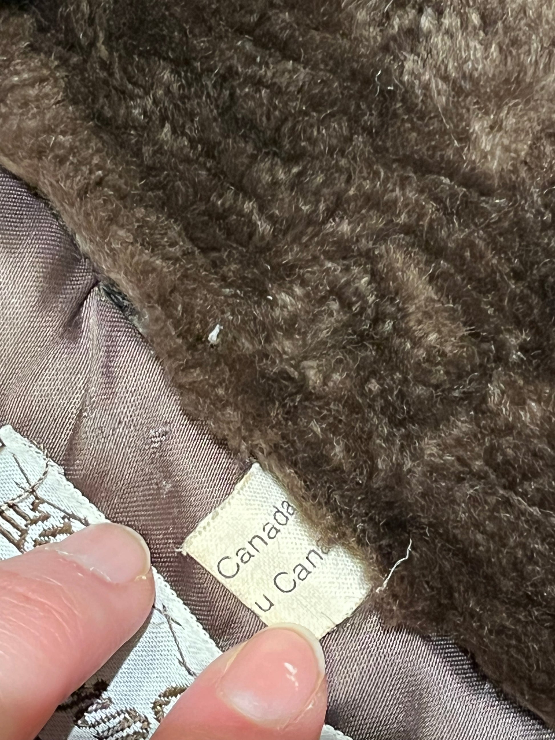 Vintage Eastern Furriers brown fur coat with hook and eye closures and two front pockets.
Although we can’t say for sure what the type of fur is, our educated guess is shorn beaver.
Made in Canada
