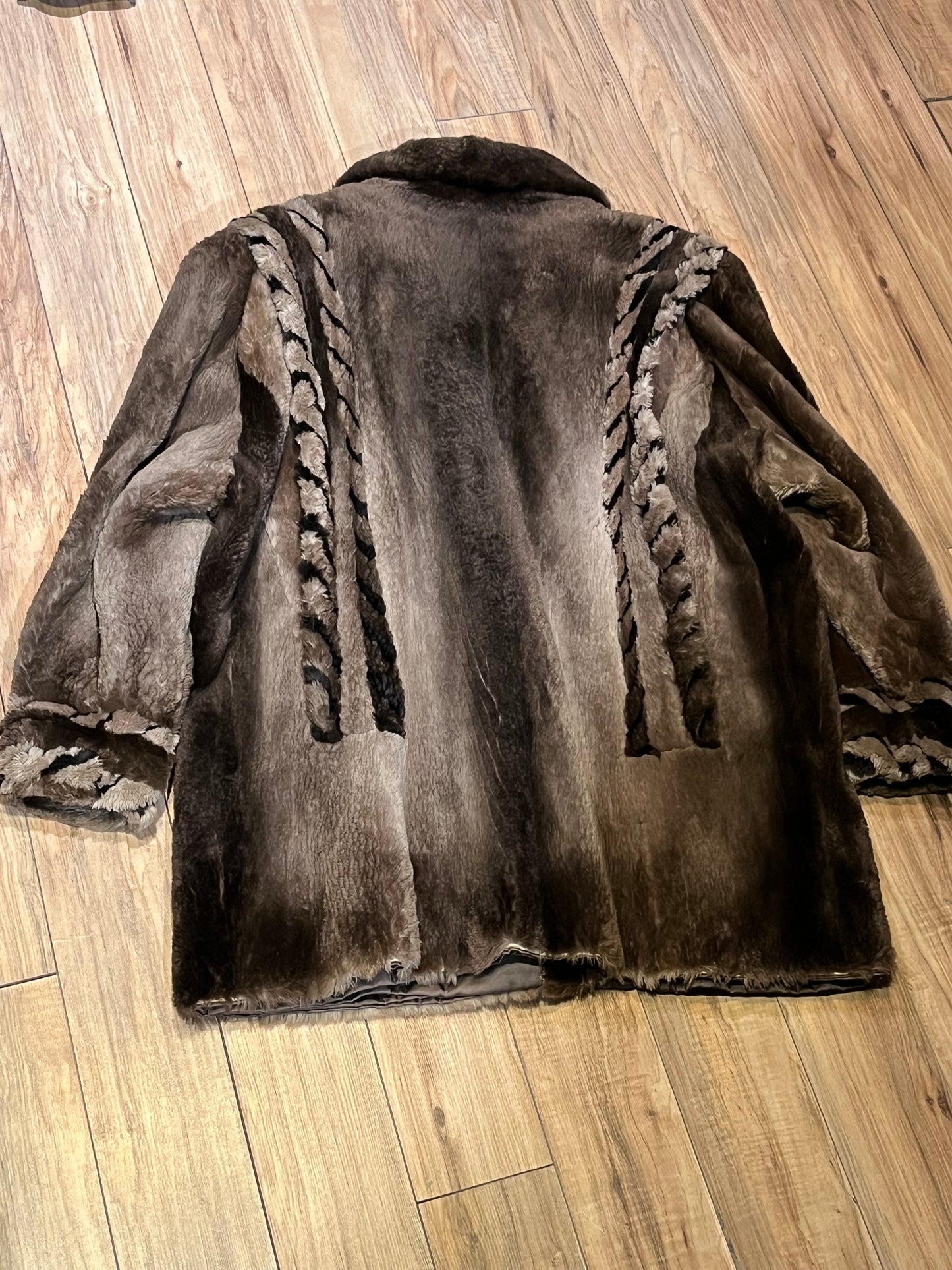 Vintage Eastern Furriers brown fur coat with hook and eye closures and two front pockets.
Although we can’t say for sure what the type of fur is, our educated guess is shorn beaver.
Made in Canada