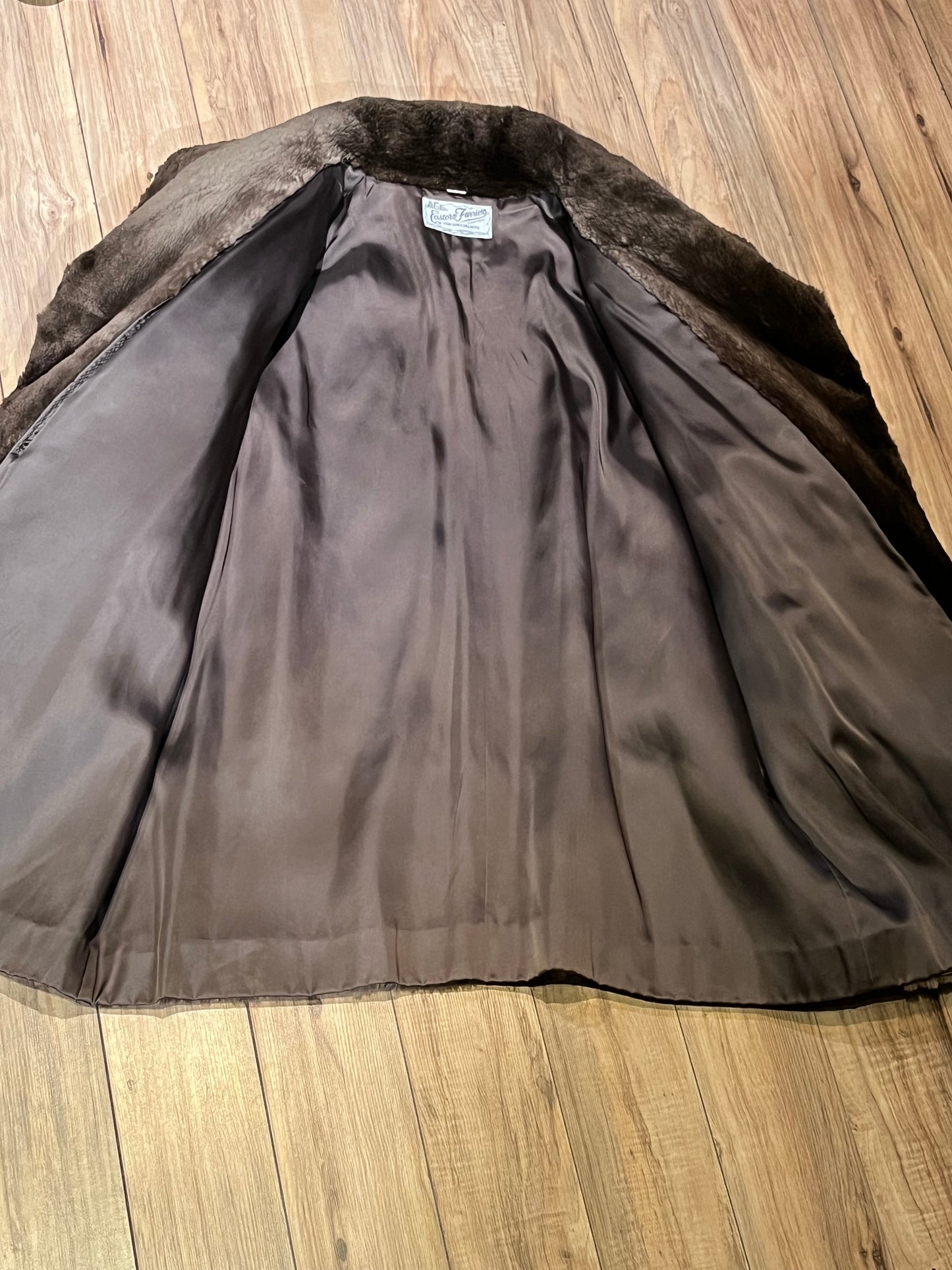 Vintage Eastern Furriers brown fur coat with hook and eye closures and two front pockets.
Although we can’t say for sure what the type of fur is, our educated guess is shorn beaver.
Made in Canada
