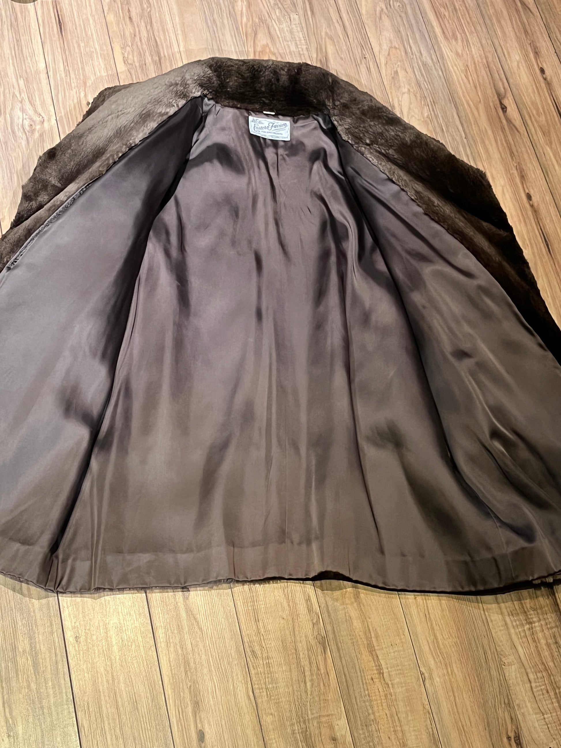 Vintage Eastern Furriers brown fur coat with hook and eye closures and two front pockets.
Although we can’t say for sure what the type of fur is, our educated guess is shorn beaver.
Made in Canada