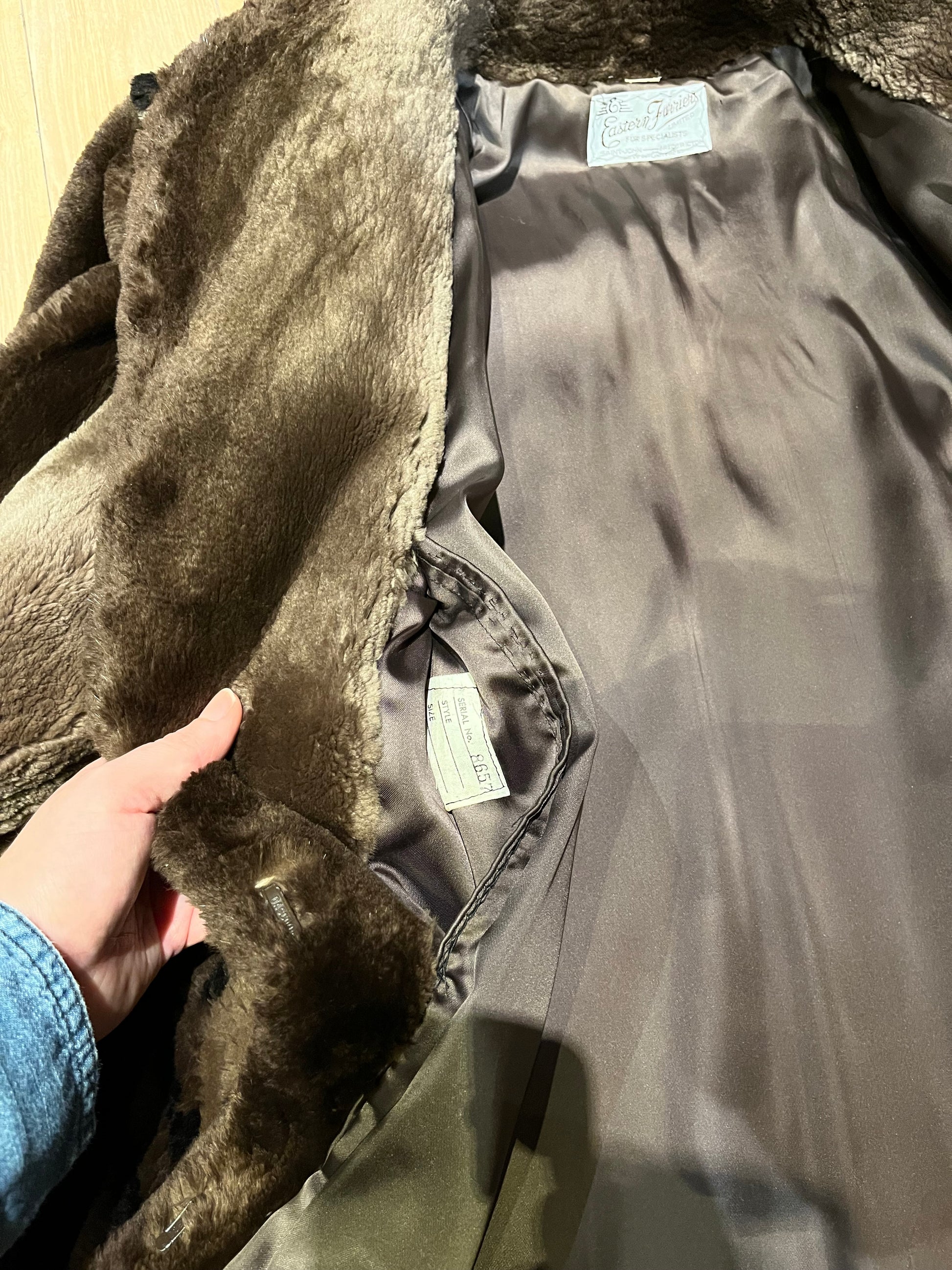 Vintage Eastern Furriers brown fur coat with hook and eye closures and two front pockets.
Although we can’t say for sure what the type of fur is, our educated guess is shorn beaver.
Made in Canada