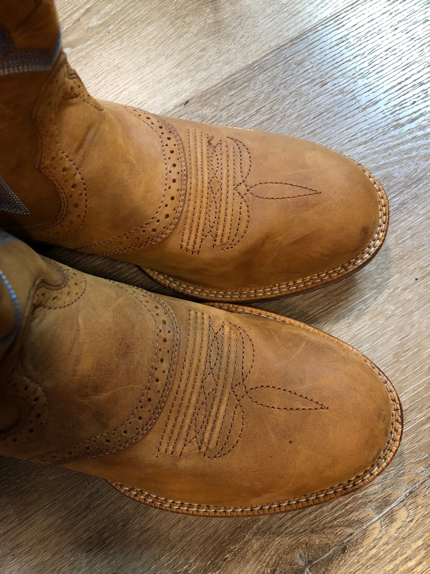 Twisted leather light brown cowboy boots with blue decorative stitching, leather lined with synthetic soles. Size 10M, 12W US/ 43 EUR