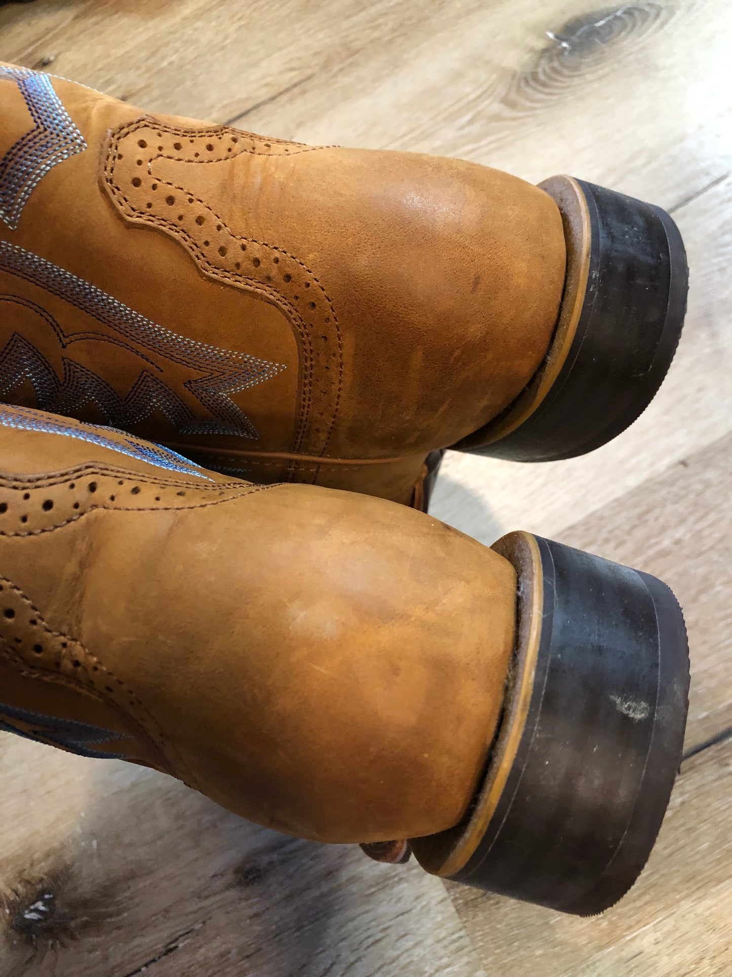 Twisted leather light brown cowboy boots with blue decorative stitching, leather lined with synthetic soles. Size 10M, 12W US/ 43 EUR