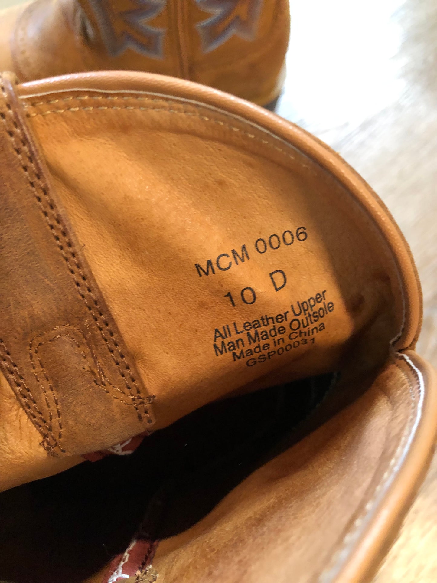 Twisted leather light brown cowboy boots with blue decorative stitching, leather lined with synthetic soles. Size 10M, 12W US/ 43 EUR