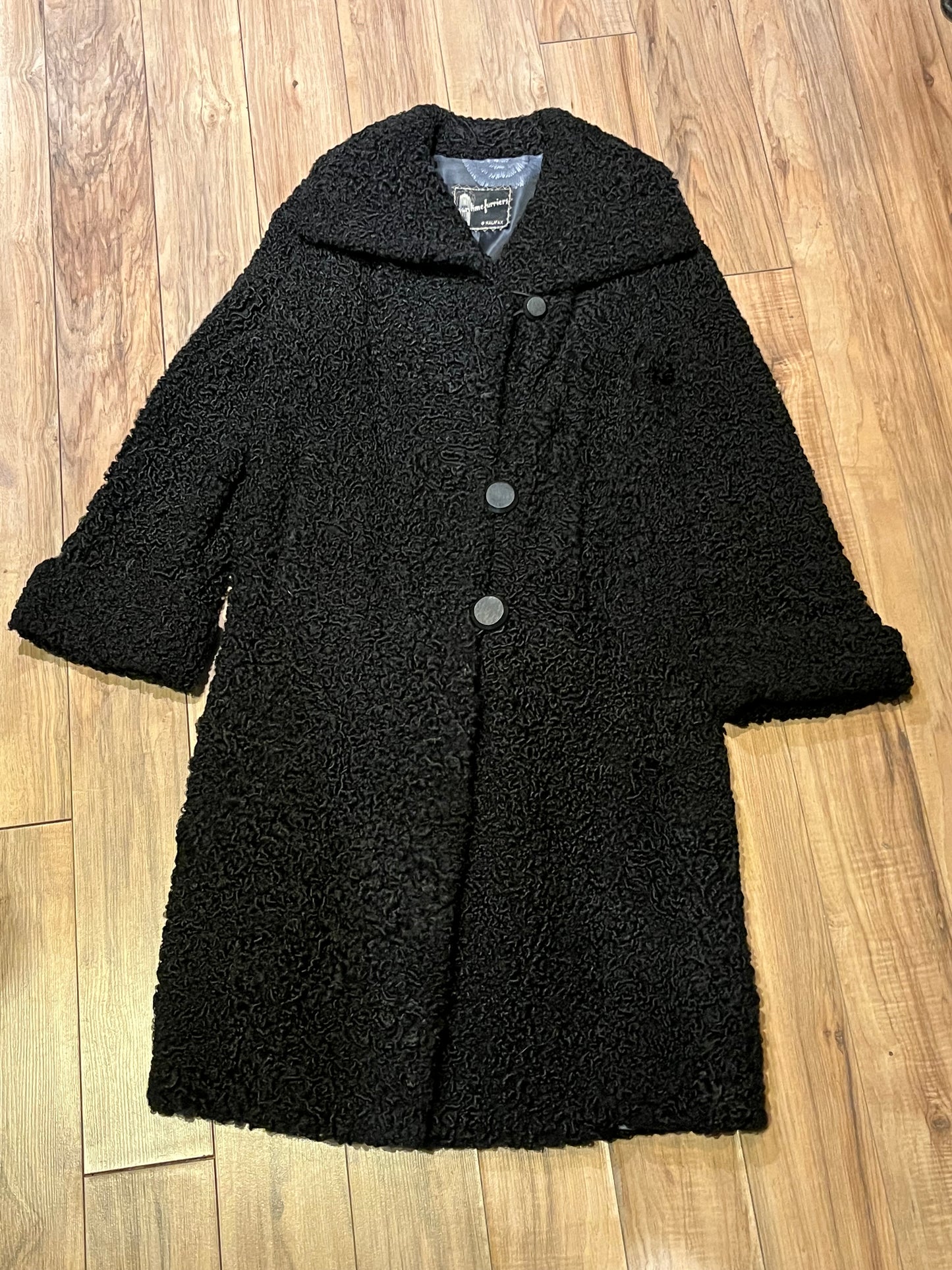 Vintage Maritime Furriers LTD black persian lamb fur coat with two front pockets, button closures and a satin lining with flower motif.
Chest 38”
