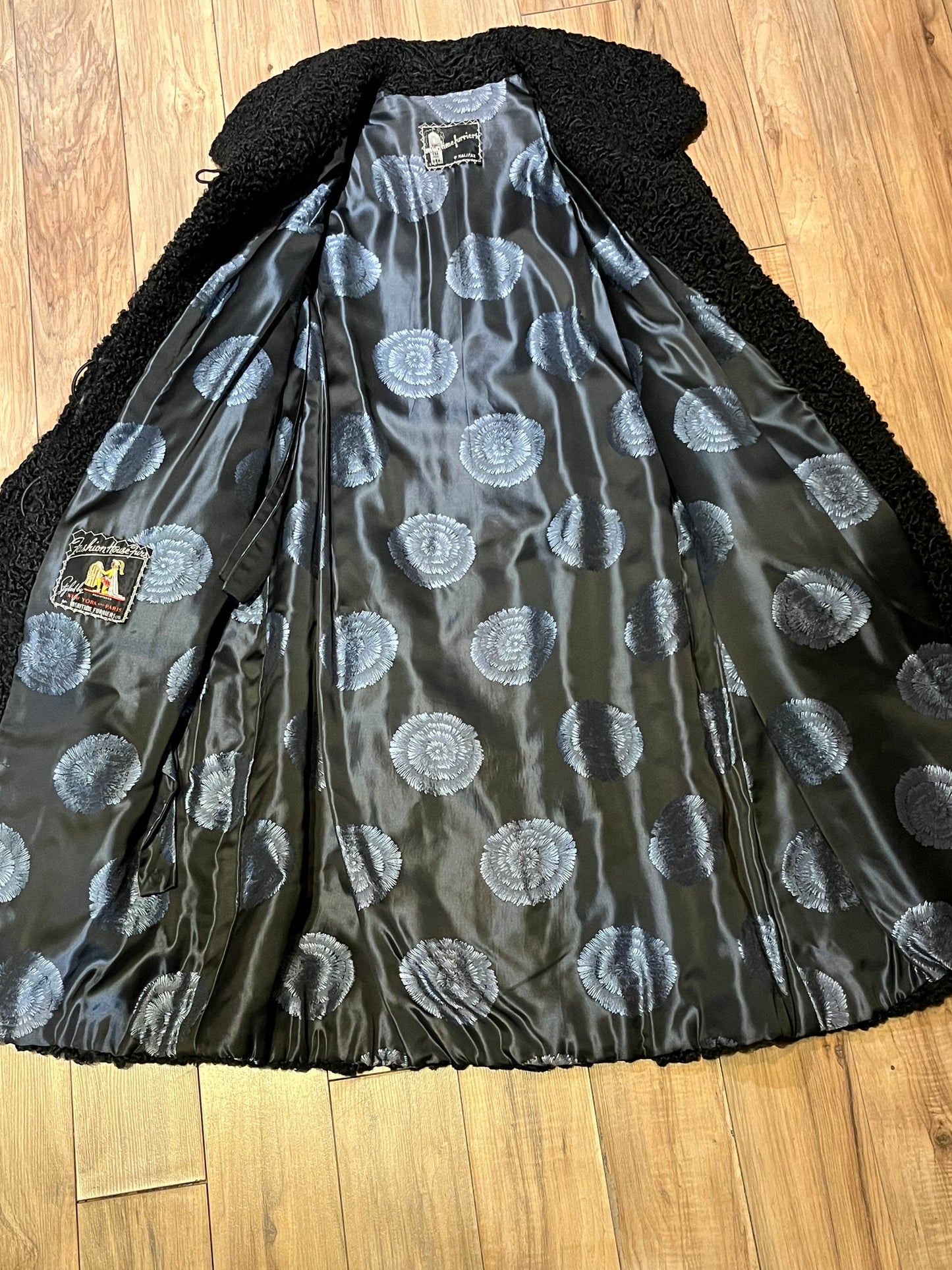 Vintage Maritime Furriers LTD black persian lamb fur coat with two front pockets, button closures and a satin lining with flower motif.
Chest 38”