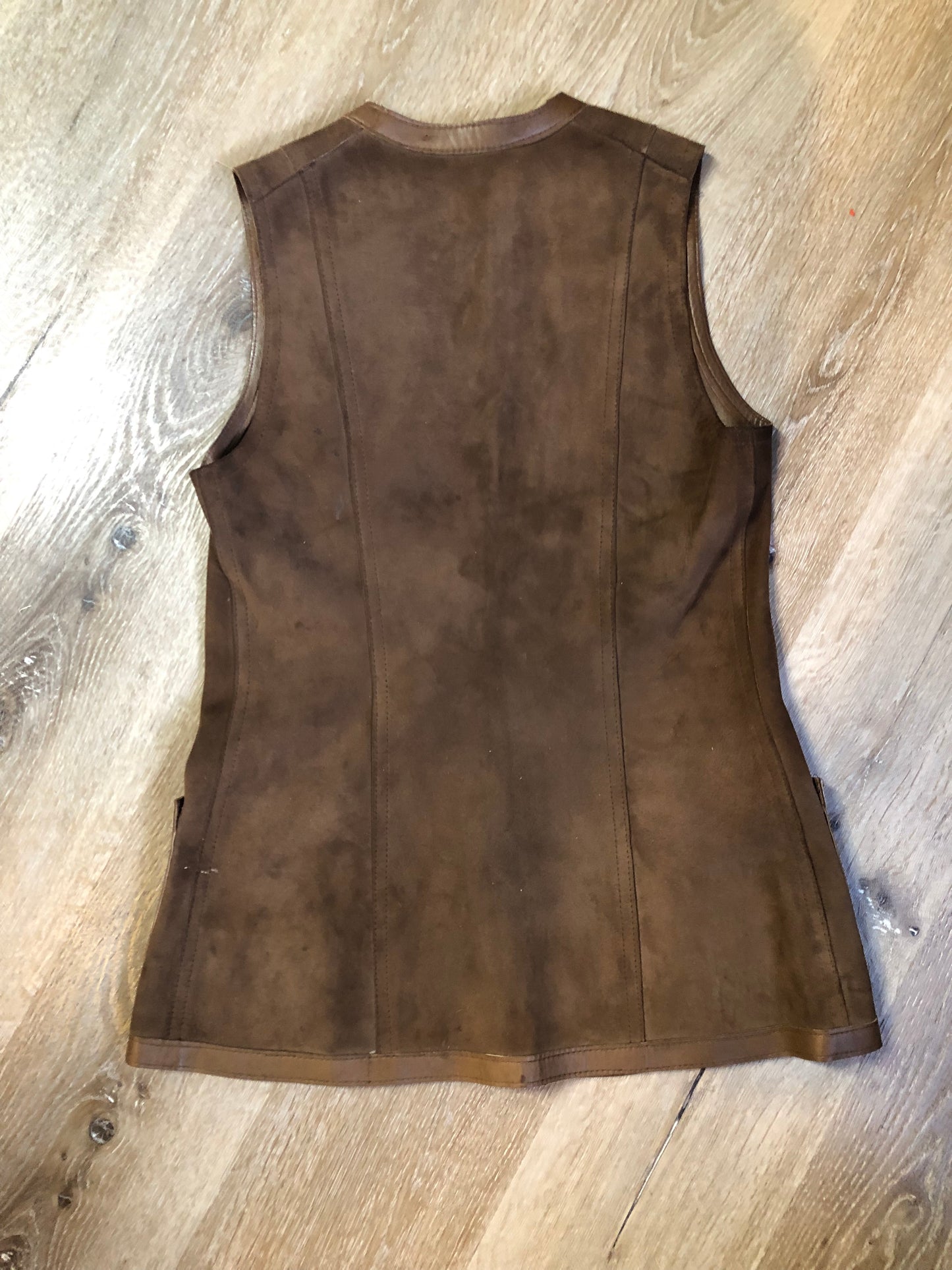 Vintage Mills Brothers deadstock 1960’s brown suede vest with large gold geometric front clasp, leather lining and trim and two patch pockets in the front. Suede and leather are buttery soft. Made in England - Kingspier Vintage