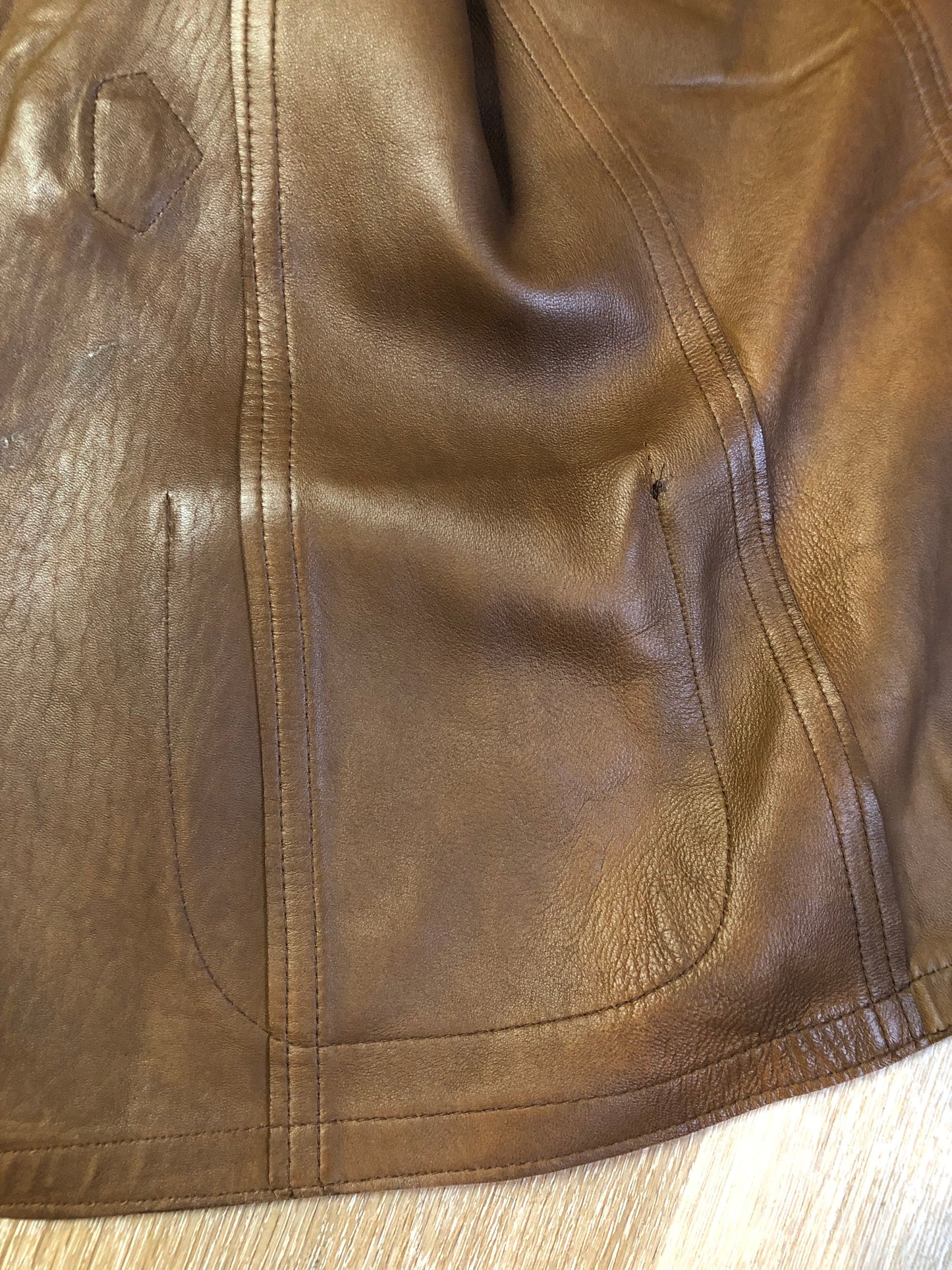 Vintage Mills Brothers deadstock 1960’s brown suede vest with large gold geometric front clasp, leather lining and trim and two patch pockets in the front. Suede and leather are buttery soft. Made in England - Kingspier Vintage