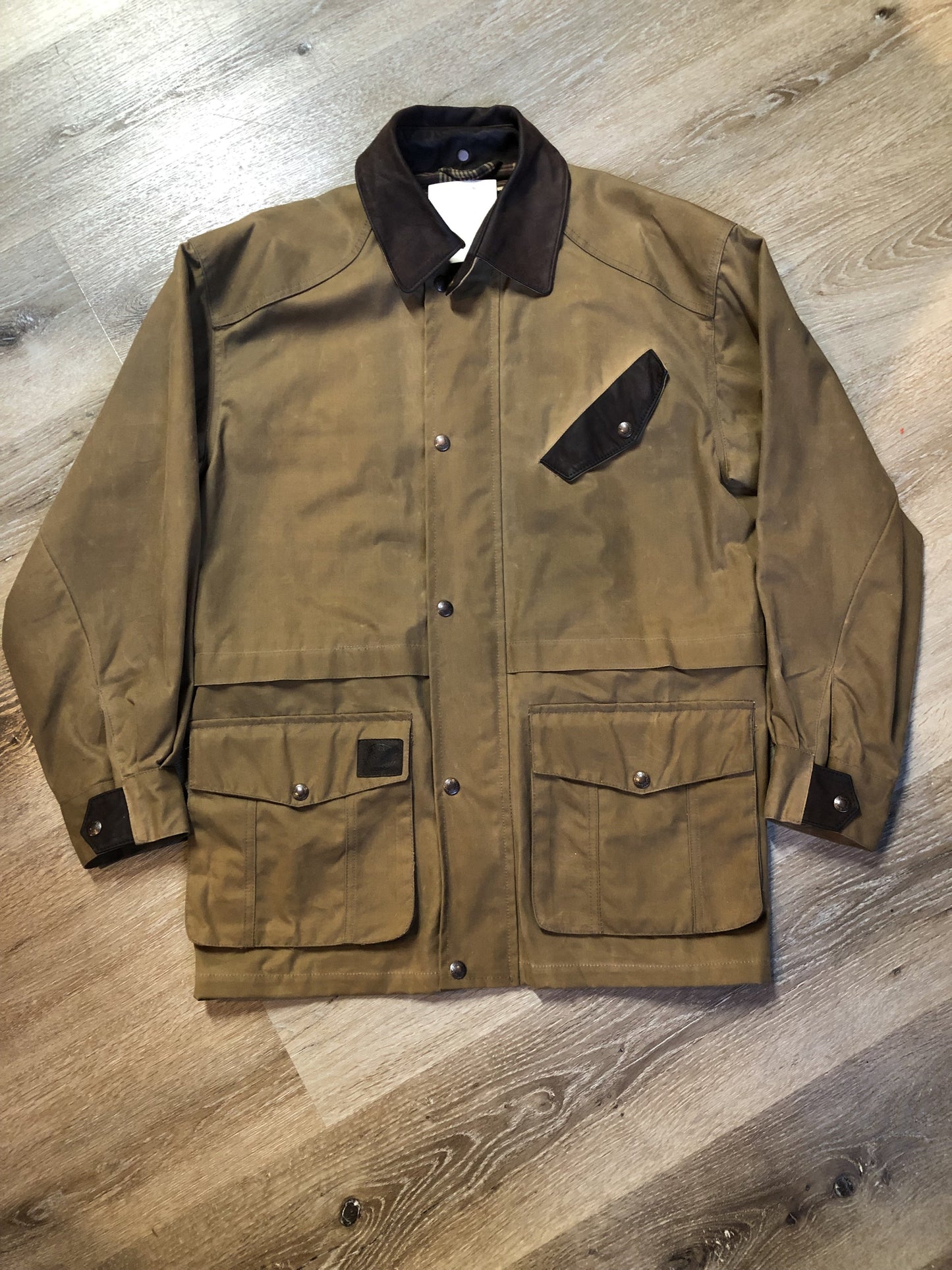 Vintage Australian Outback Collection Oilskin chore jacket with snap and zipper closure, flap pockets, wax cotton shell, plaid lining and leather trim. NWOT. Made in Canada - Kingspier Vintage