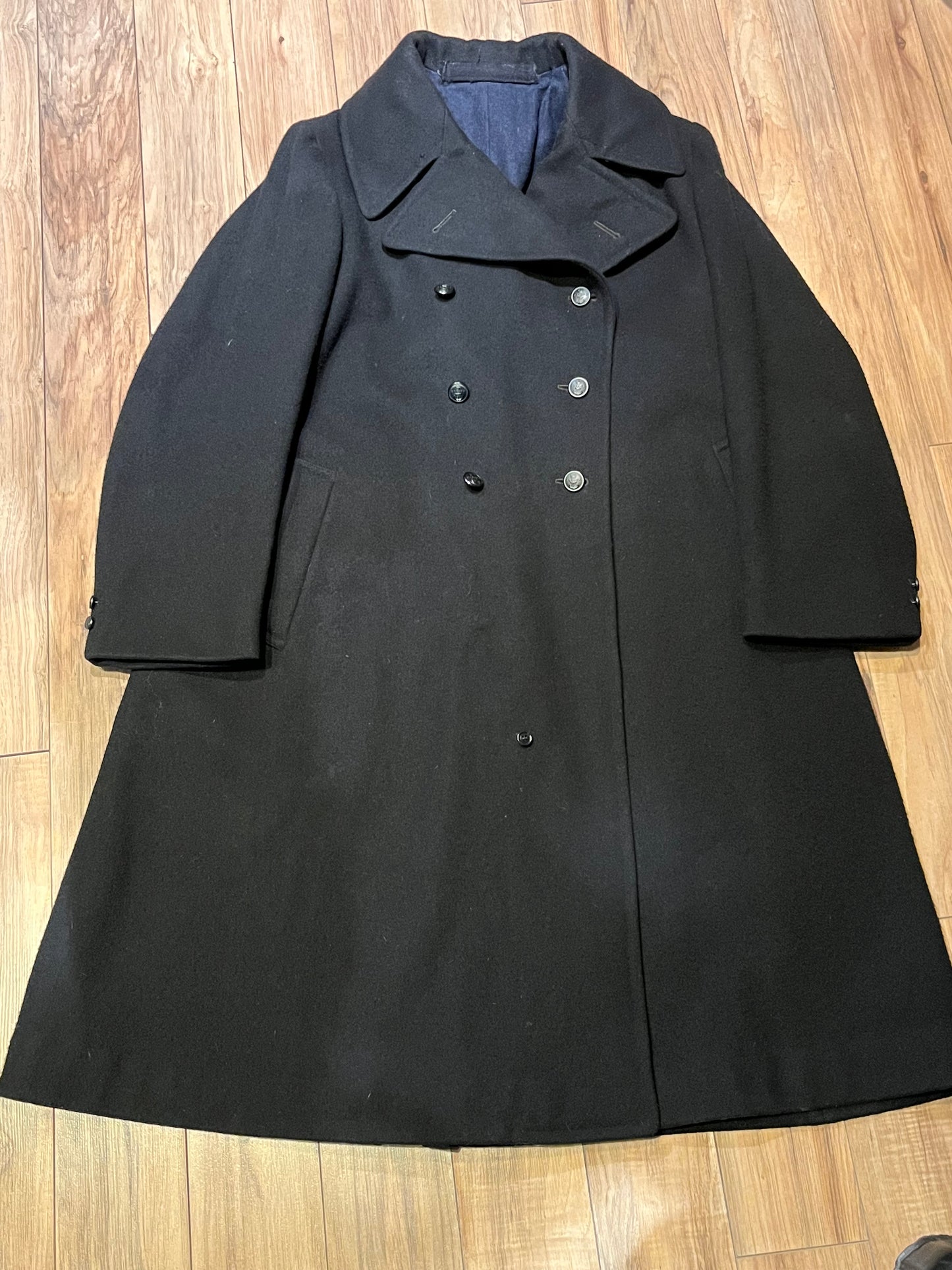 Vintage black 100% wool double breasted long naval uniform coat by Cowell Prince Pants and Clothing Co. with partial lining, two front pockets and two inside pockets.
Size 2, chest 44”