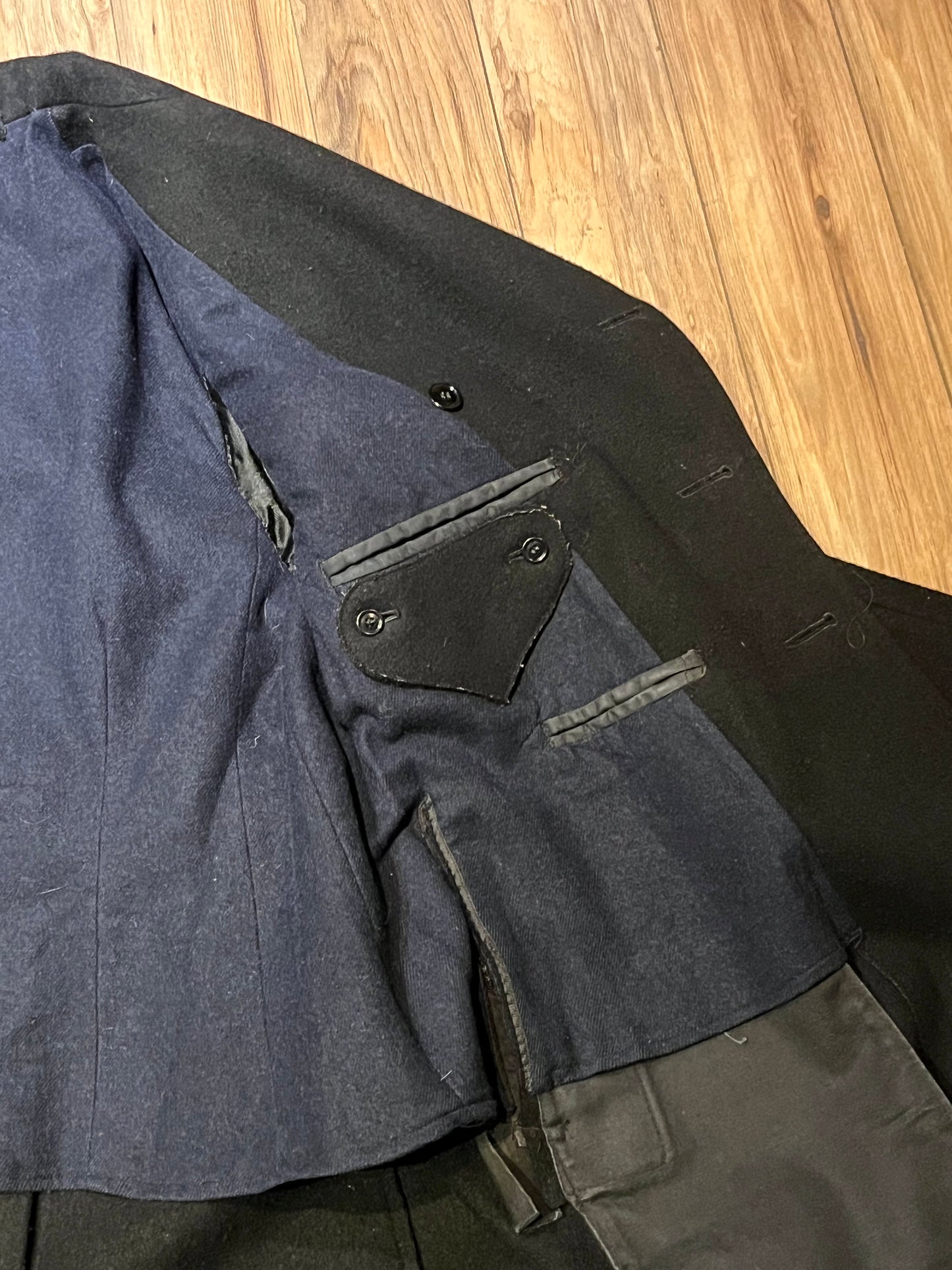 Vintage black 100% wool double breasted long naval uniform coat by Cowell Prince Pants and Clothing Co. with partial lining, two front pockets and two inside pockets.
Size 2, chest 44”